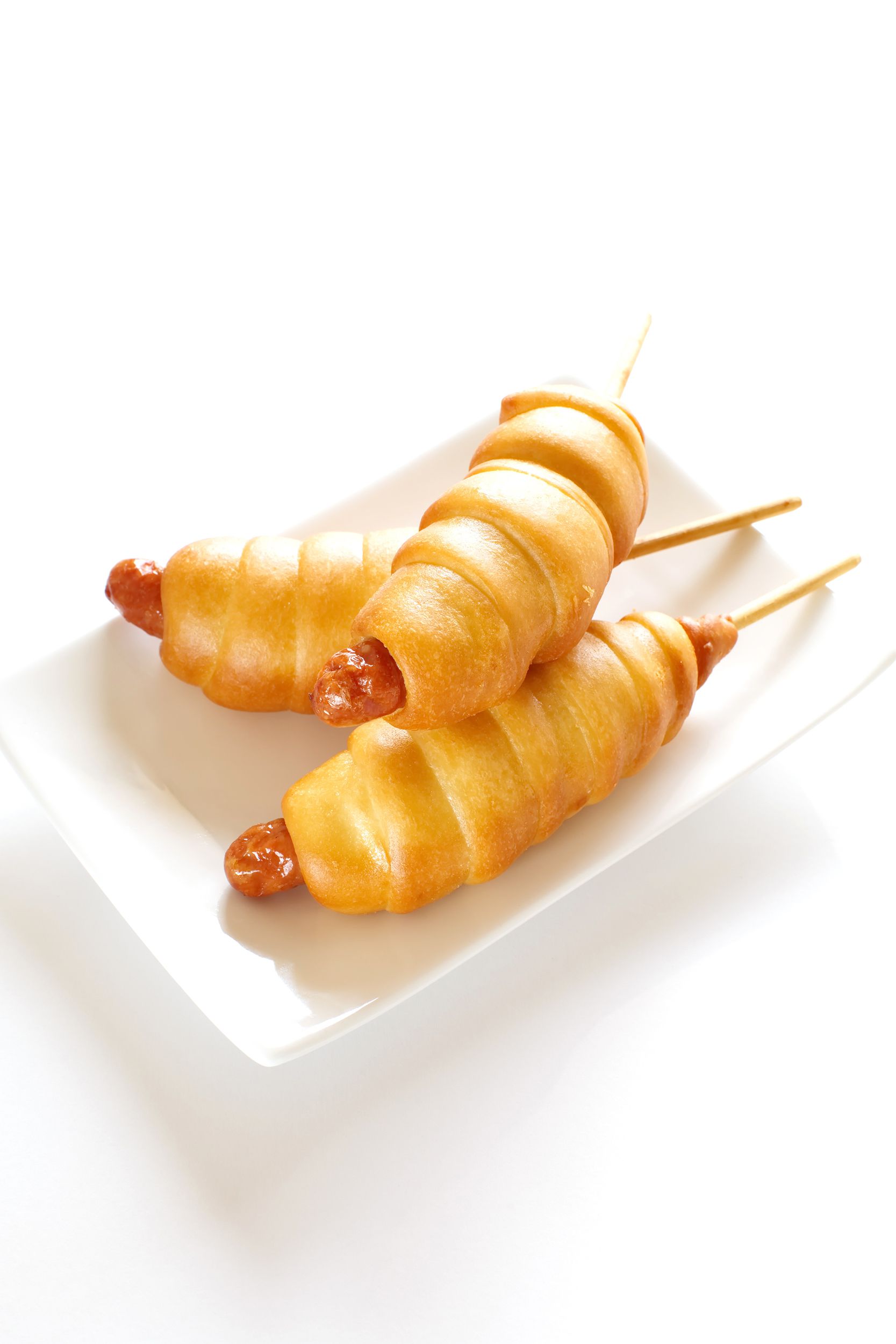 Hot dogs on a stick wrapped in dough