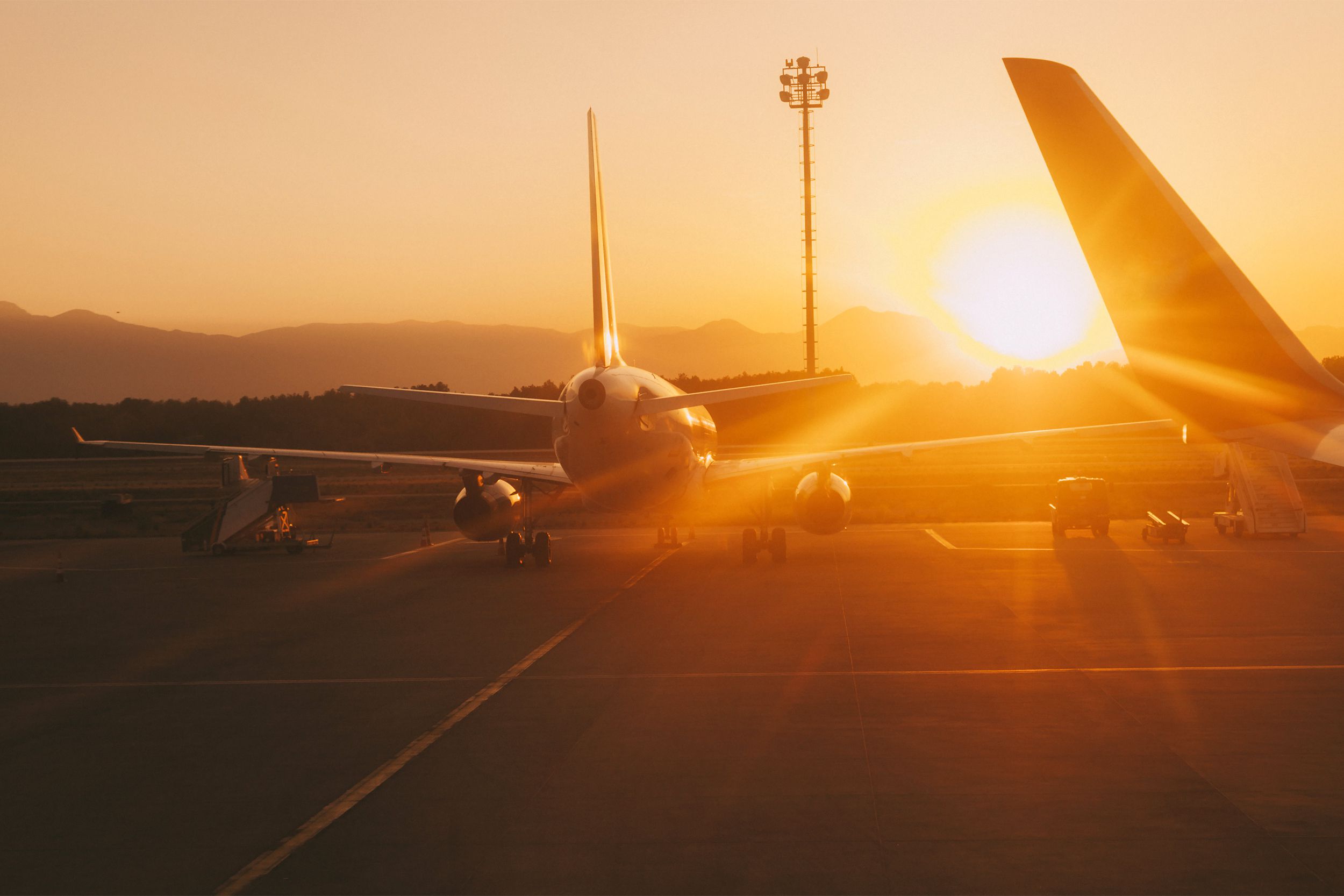 Sunset on the runway with an airplane