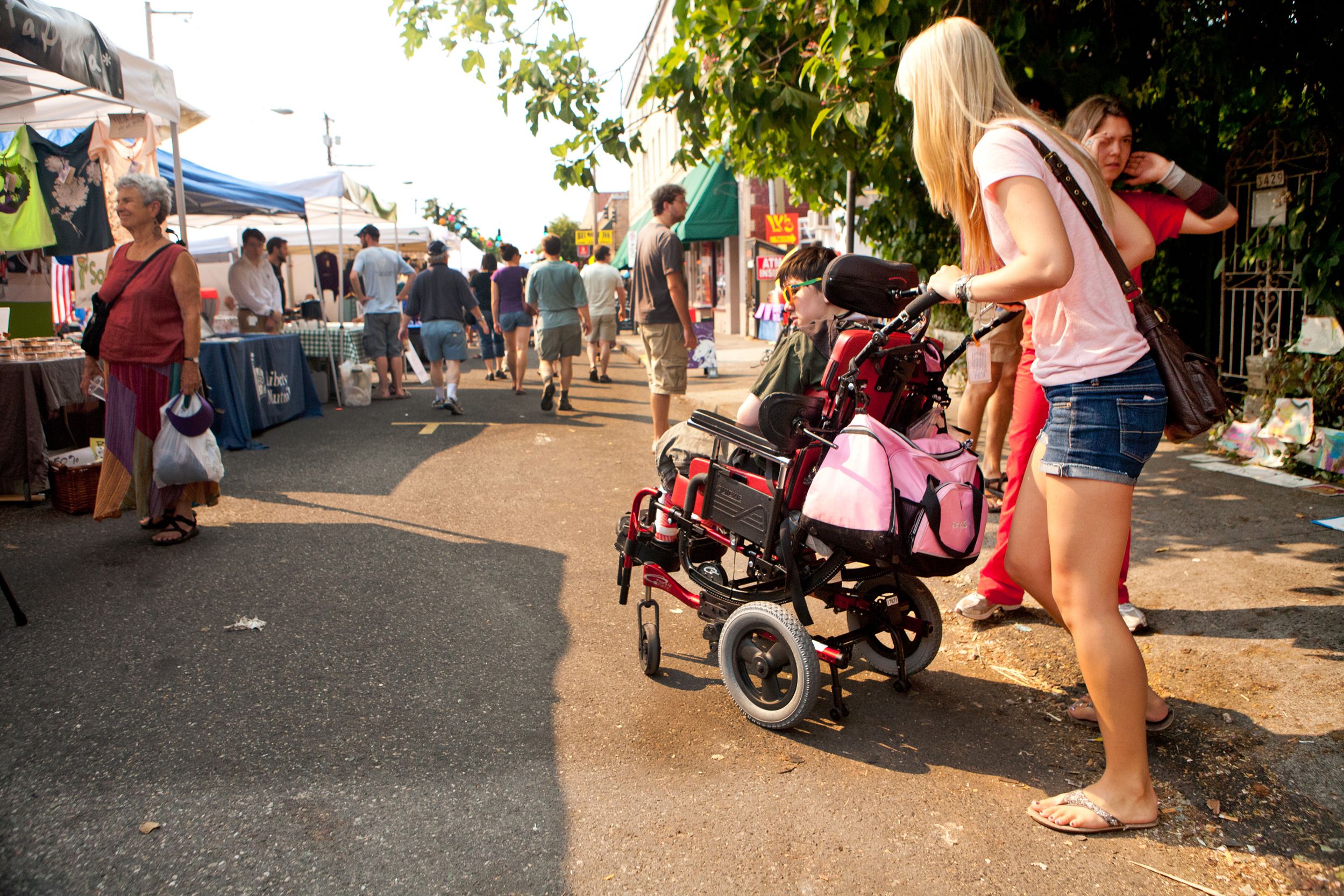 woman pushing chair through market in portland