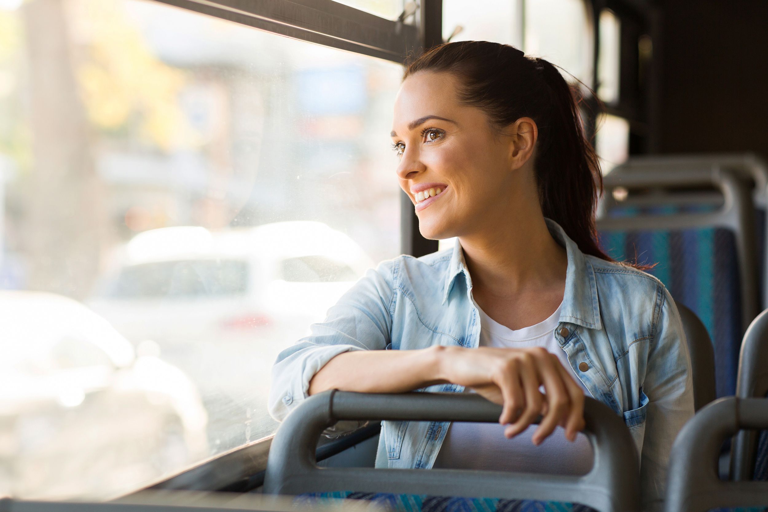 young woman taking bus to work