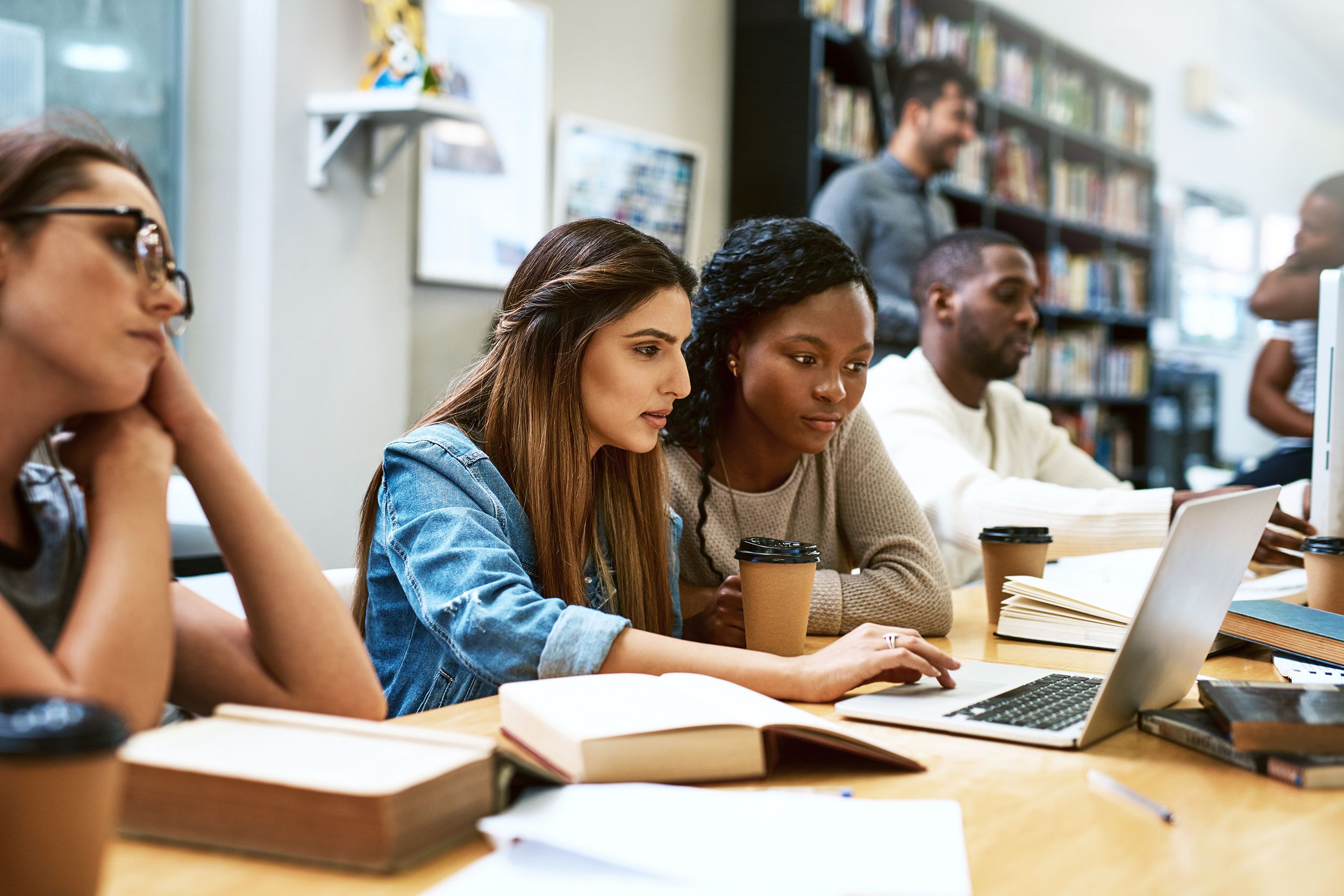 group of college students in the library working together