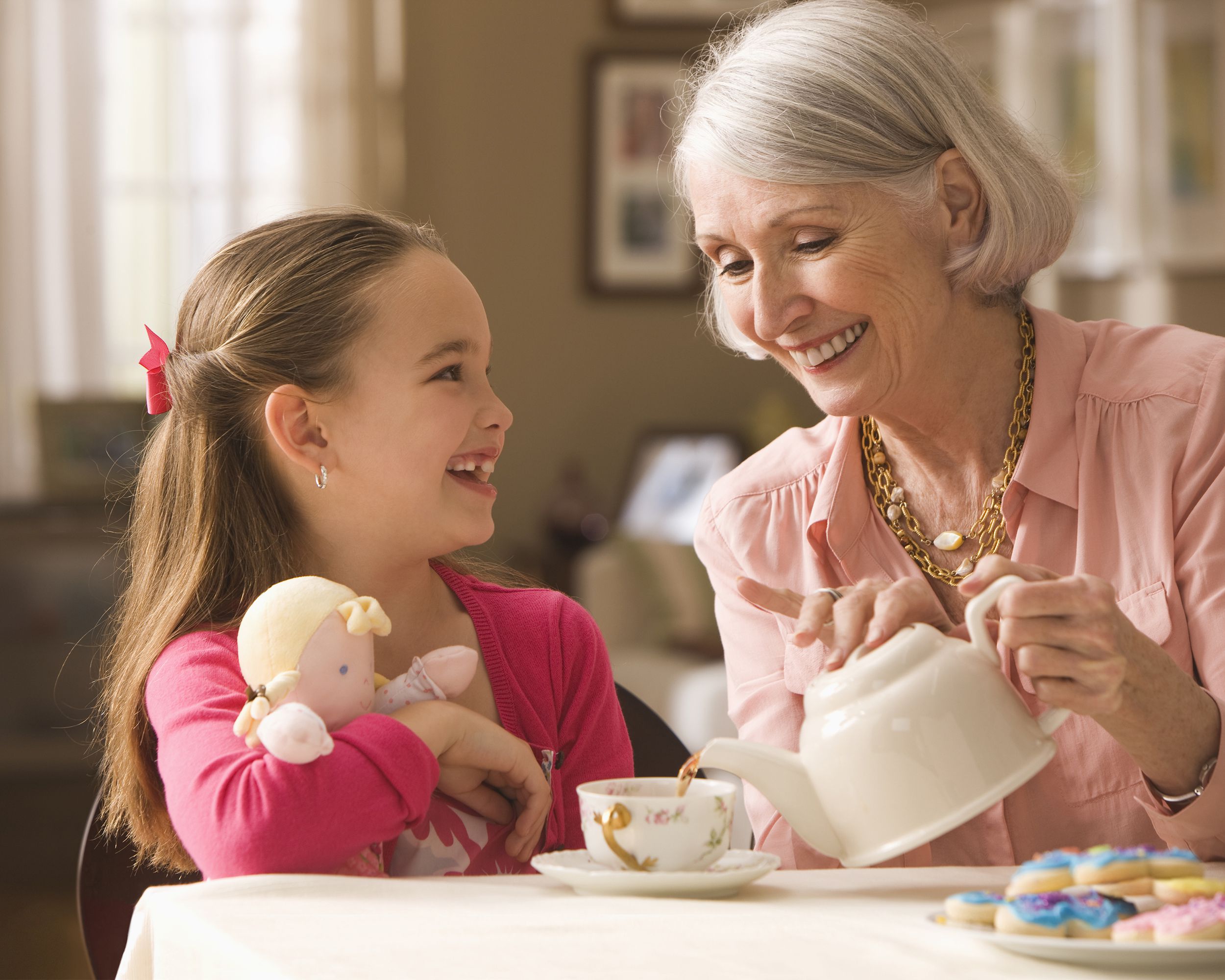grandmother and granddaughter having tea party