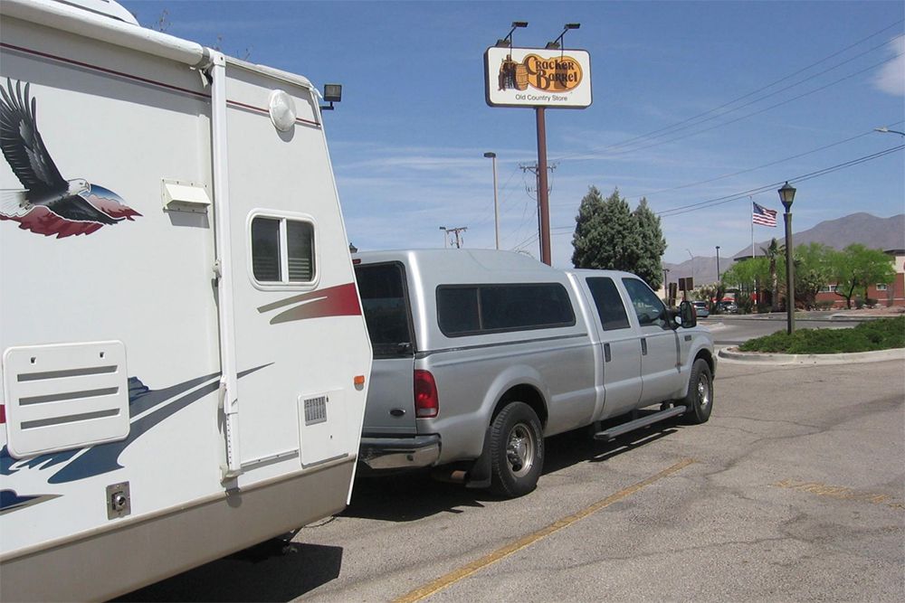 truck with RV parked in parking lot of Cracker Barrel