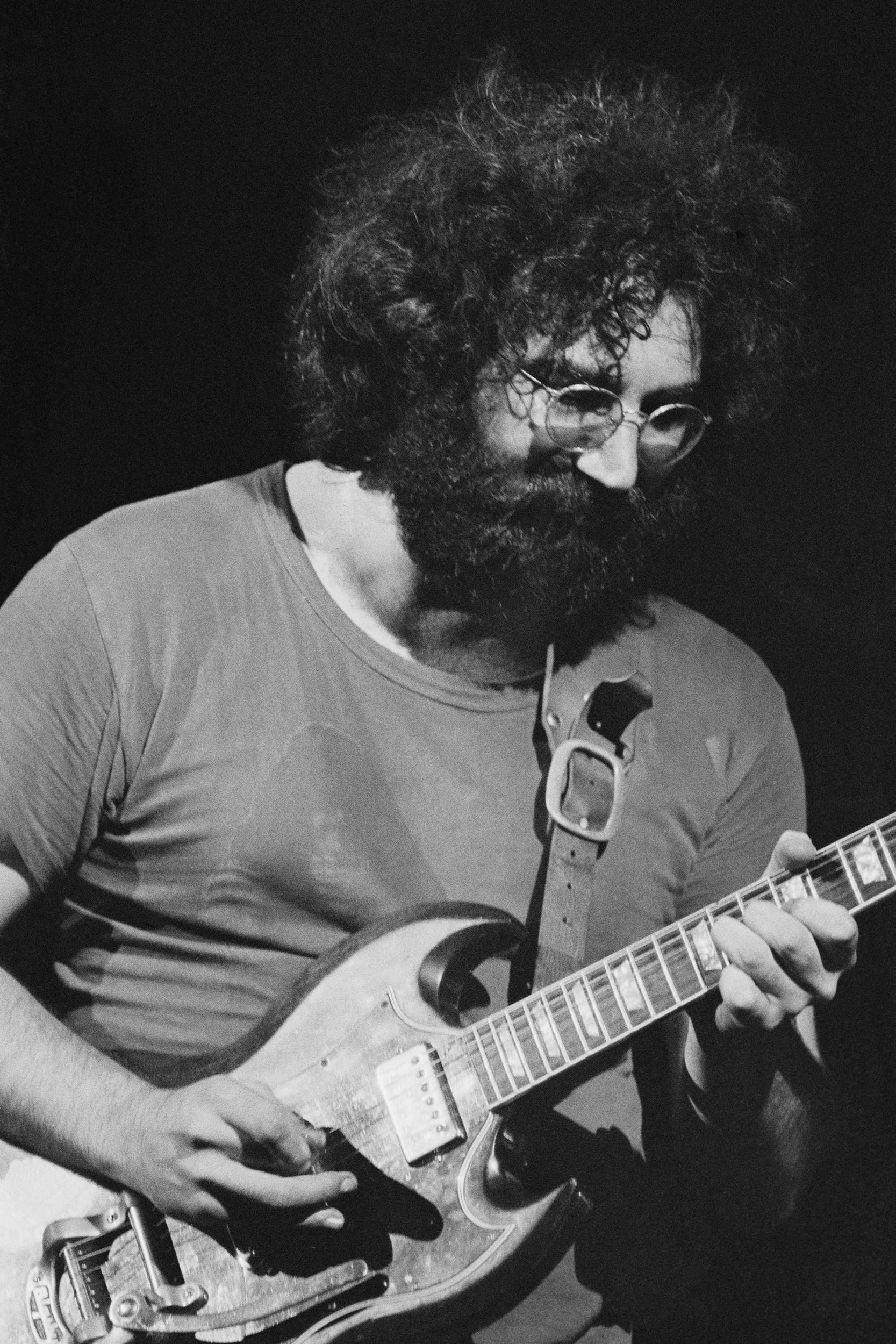singer and guitarist Jerry Garcia (1942 - 1995) performing with American rock group The Grateful Dead, at the Woodstock Music Festival, Bethel, New York, 16th August 1969
