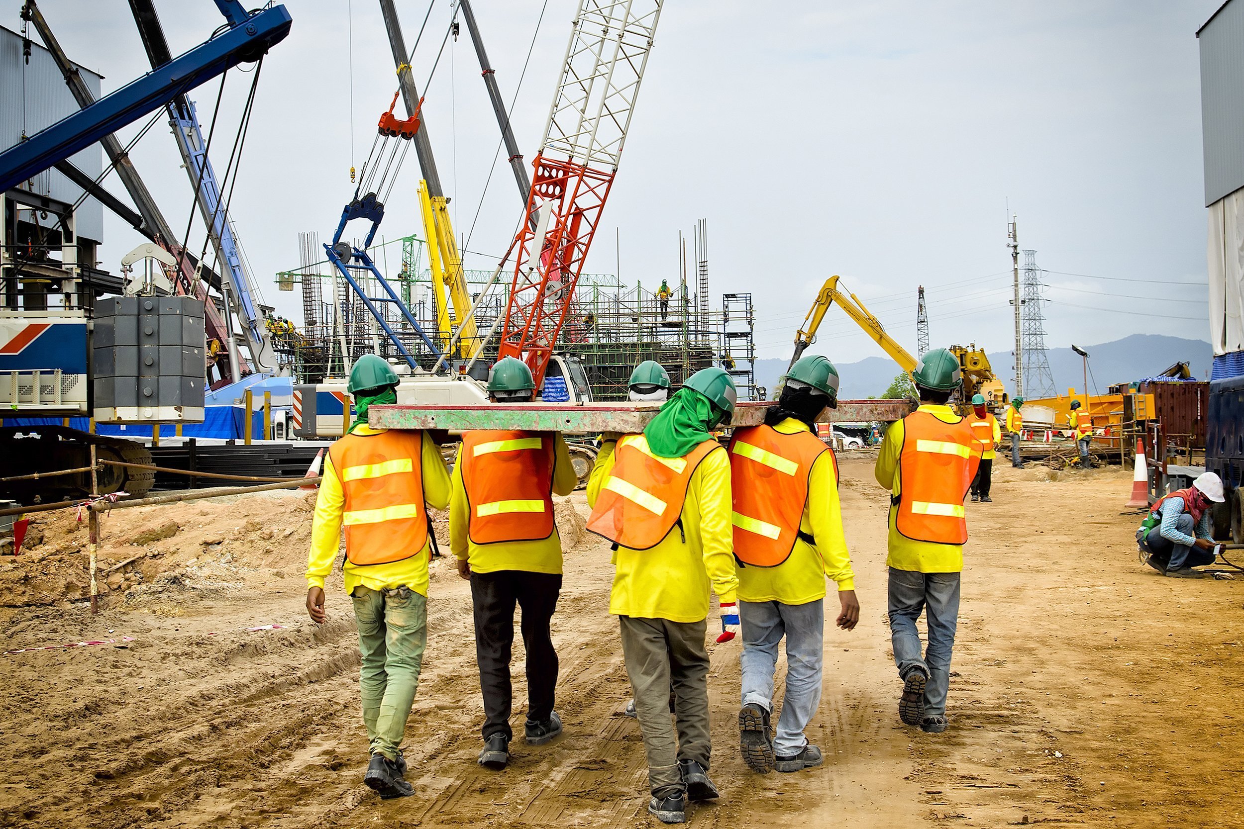 Shot of construction workers walking away on a construction site