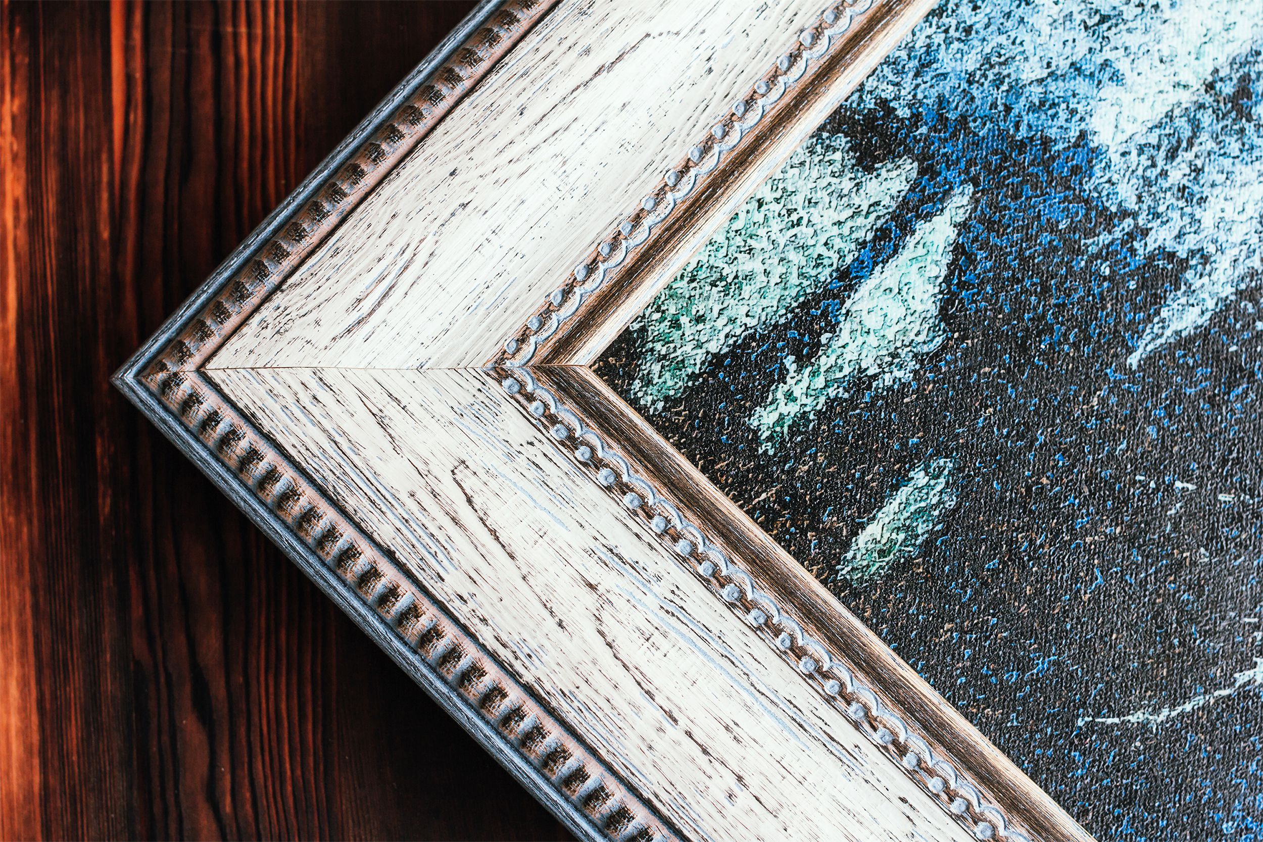 Corner of artwork in wooden frame