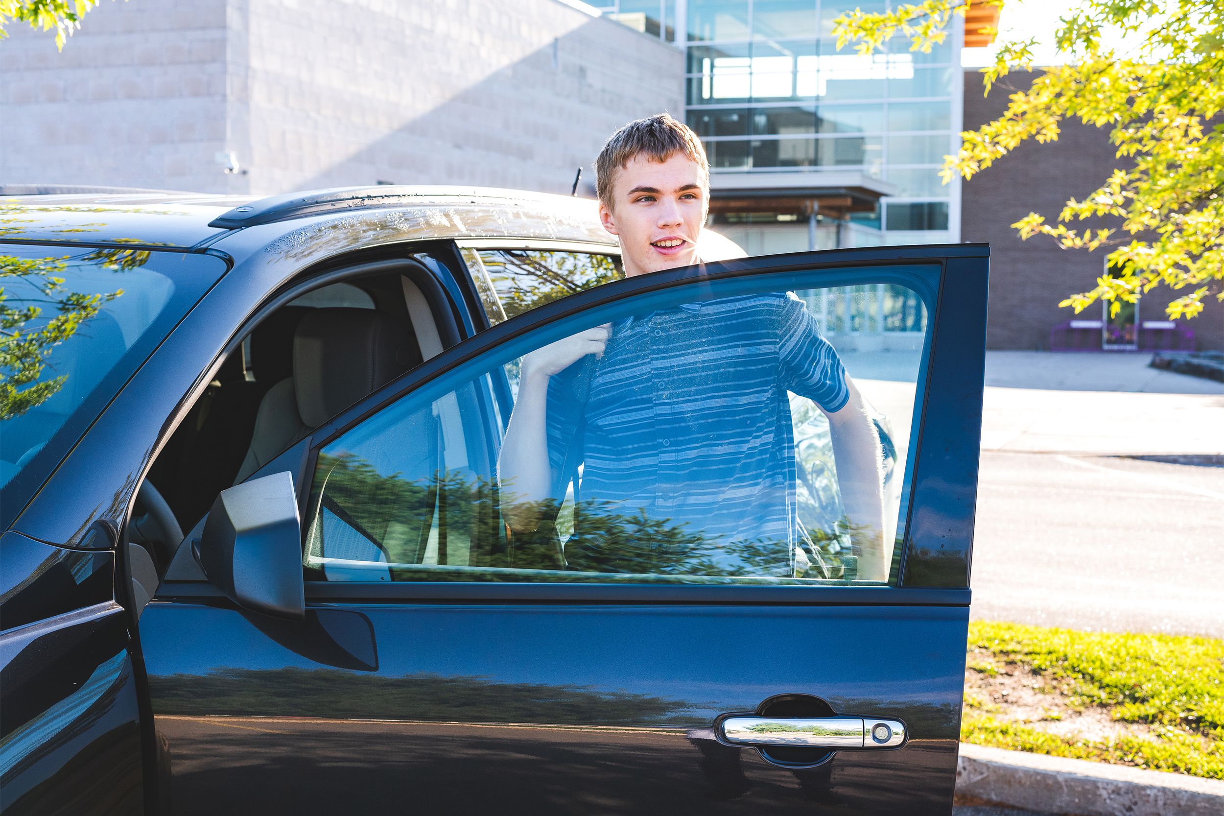 Teenager getting out of his car