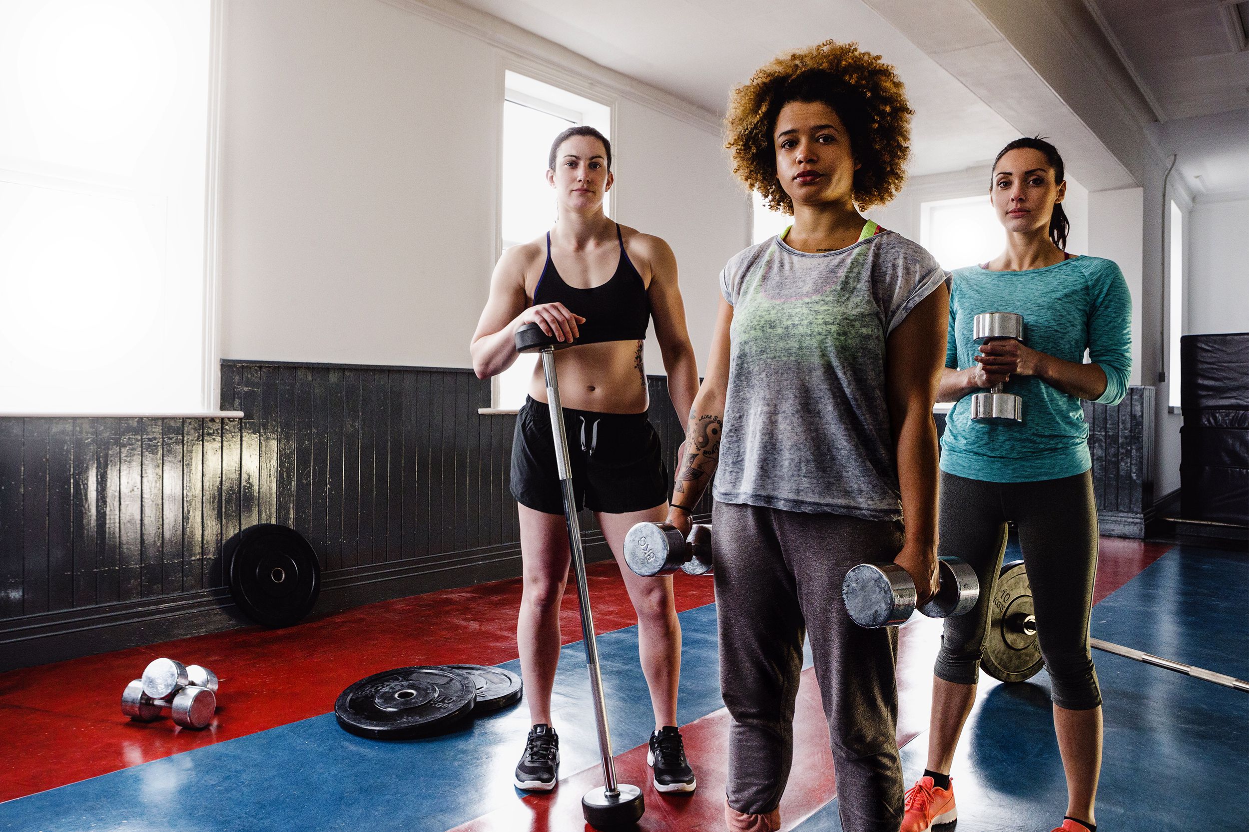Woman standing in a gym looking at the camera