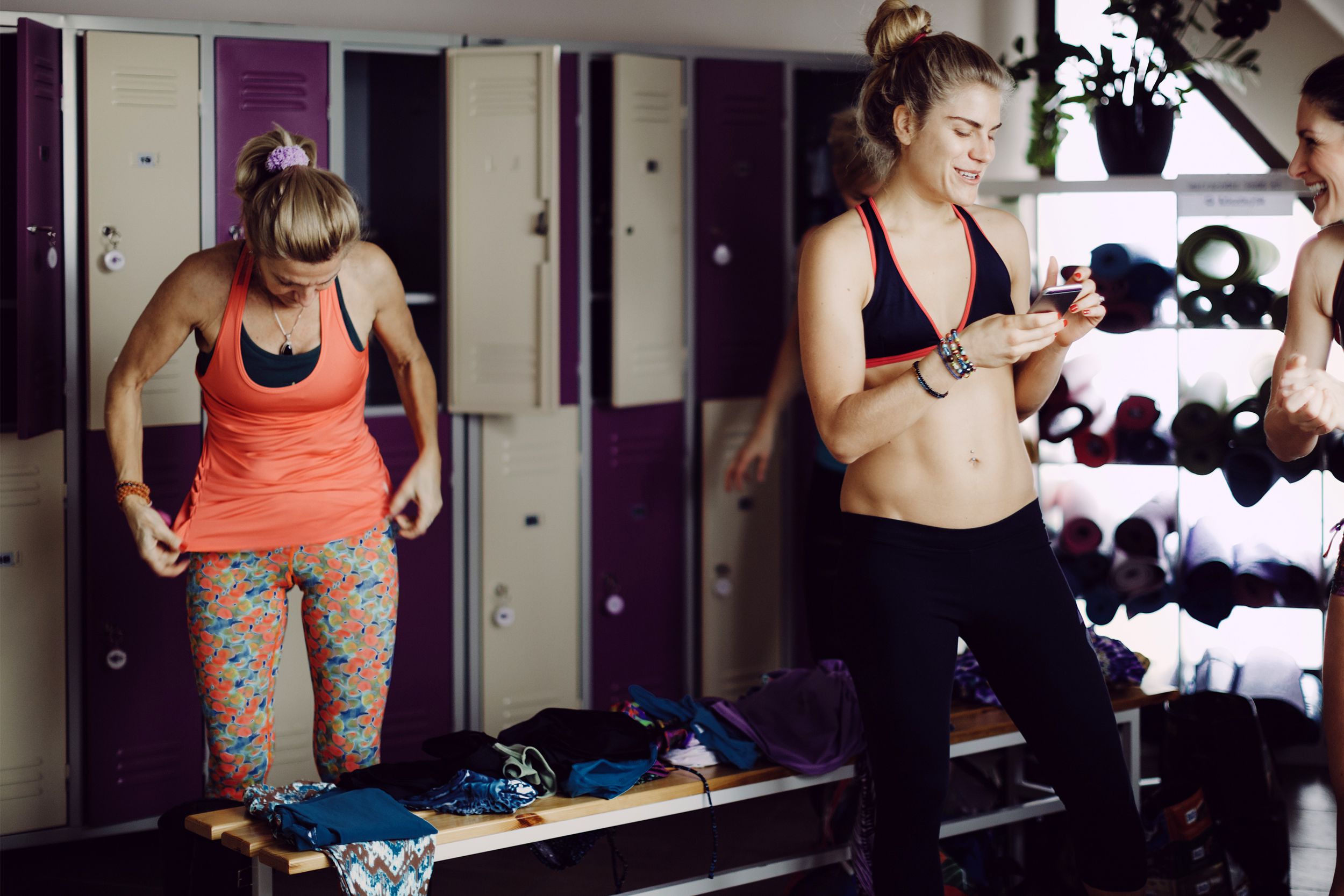 Women talking and getting dressed in a locker room