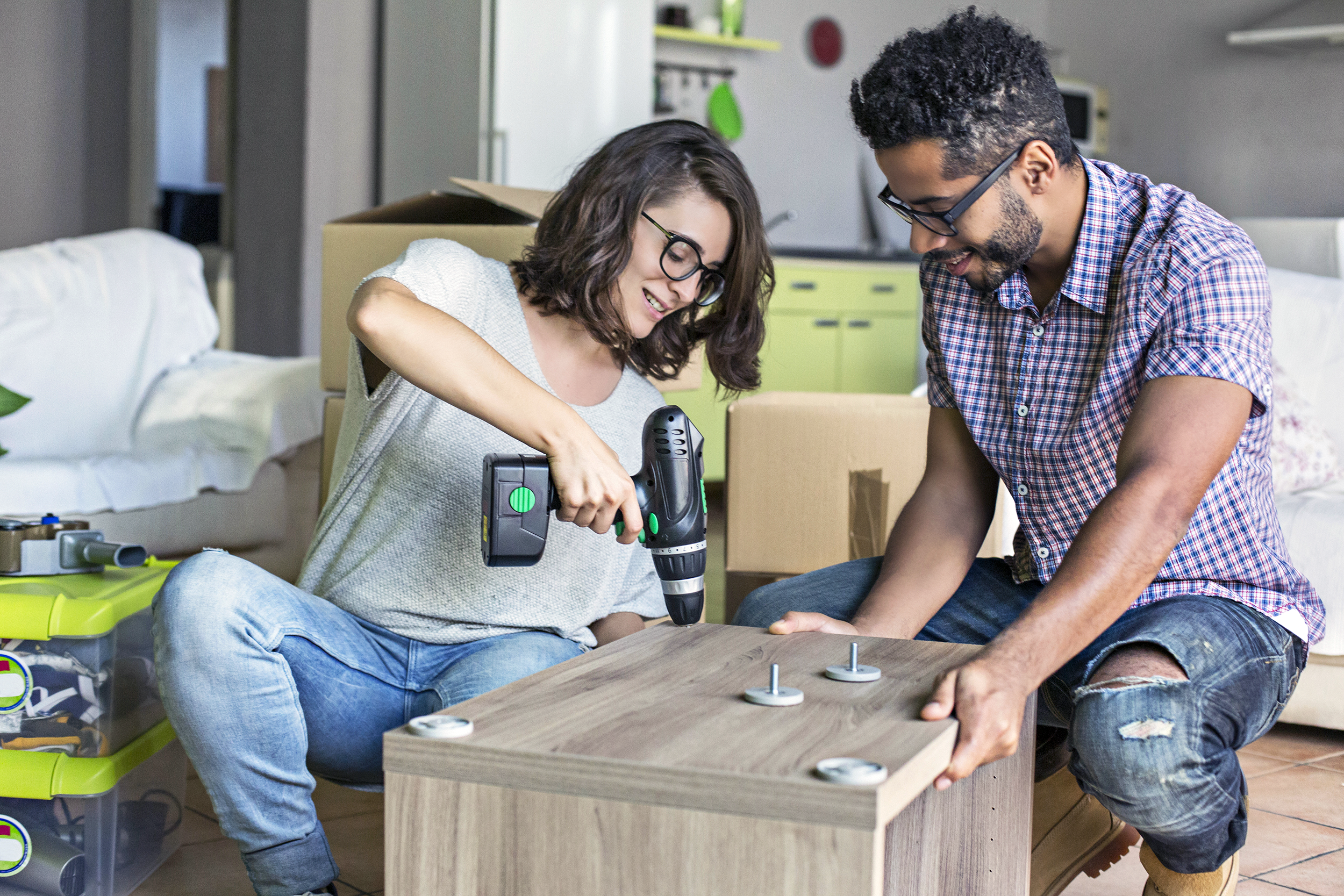 Couple putting together new furniture