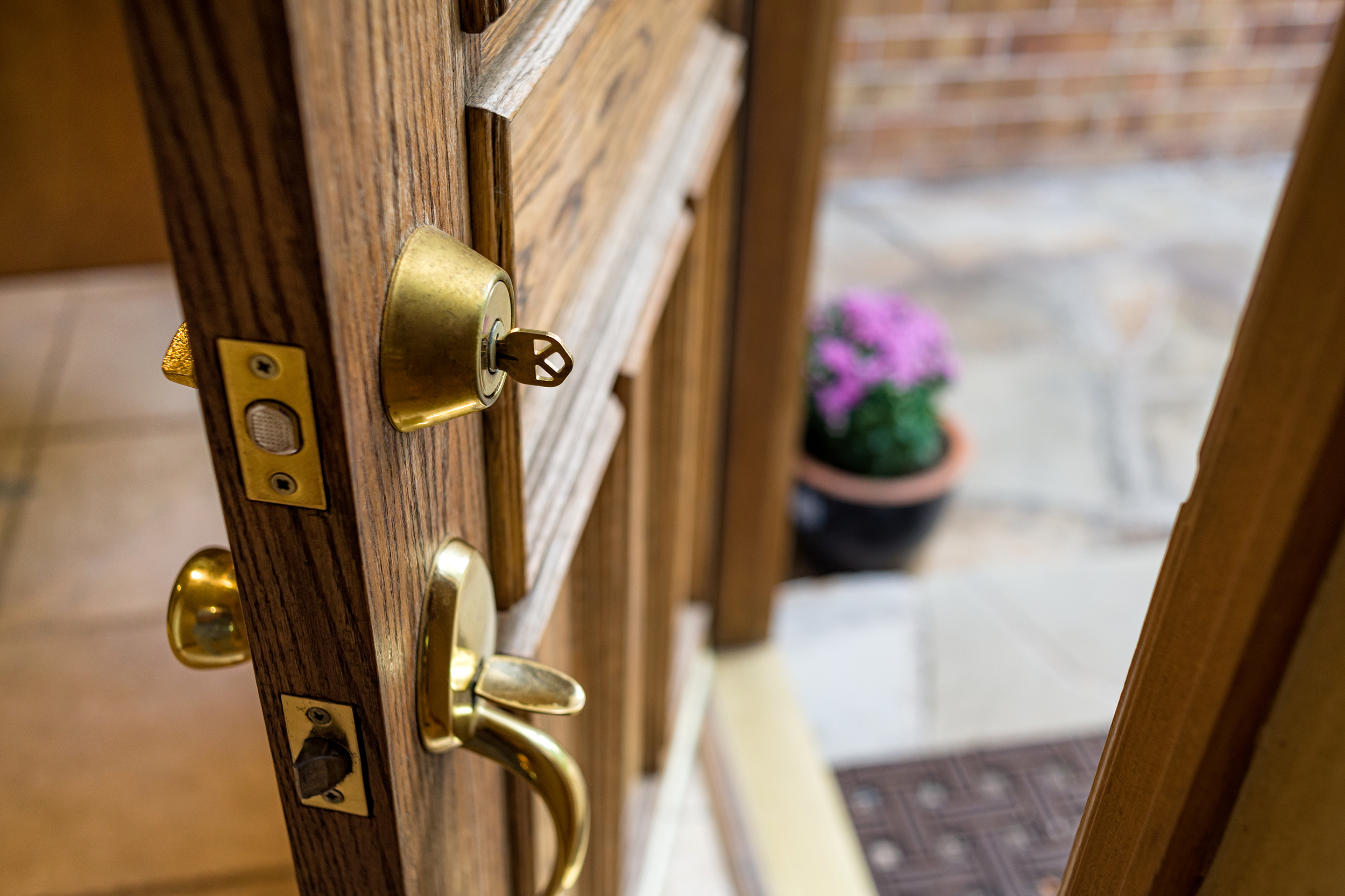 Open front door with a key in the lock