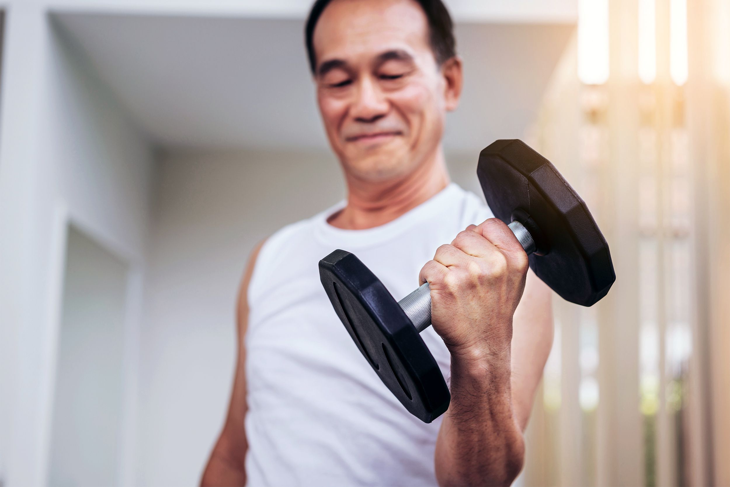Senior man lifting weights