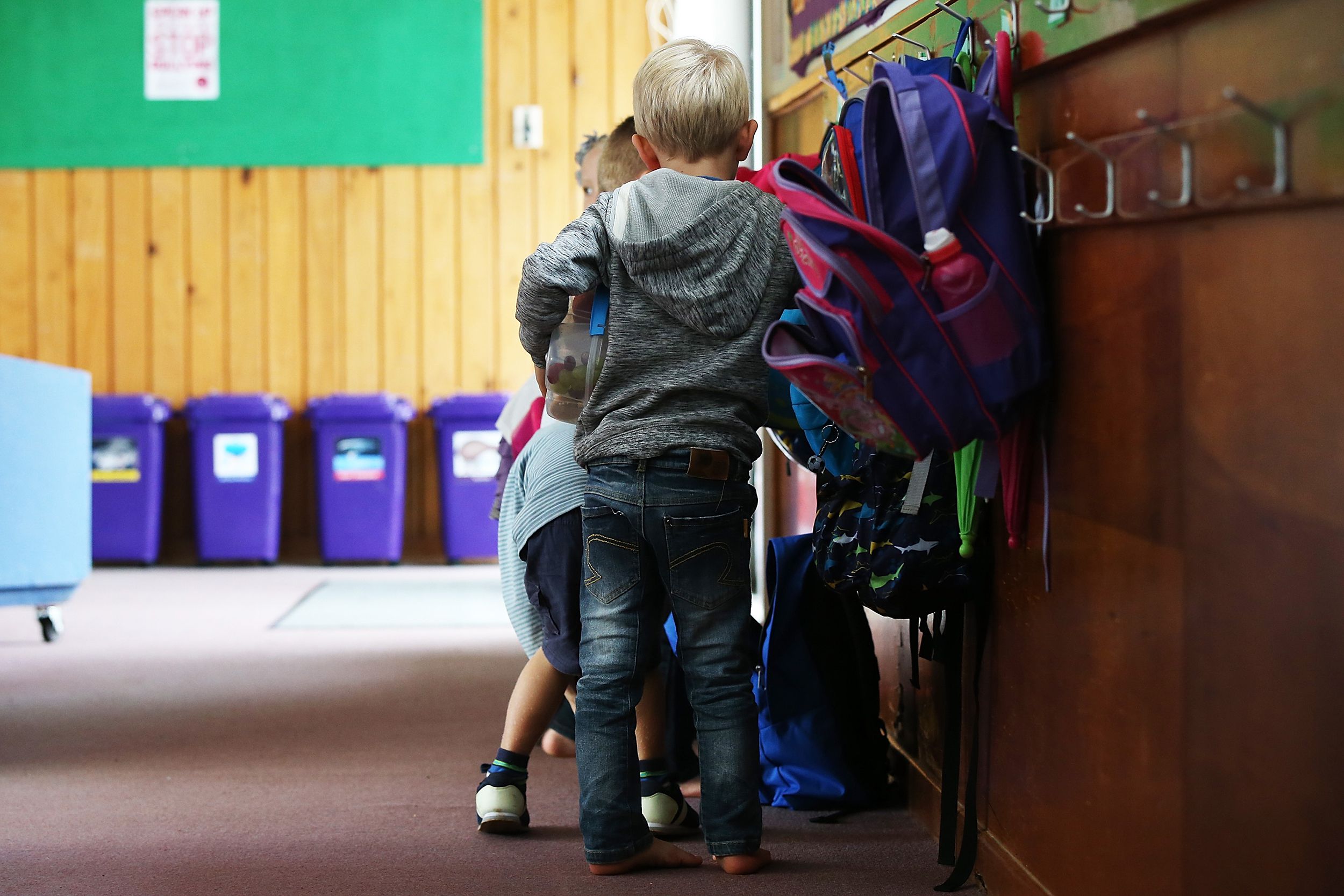 primary school children pulling lunches out of backpacks in new zealand