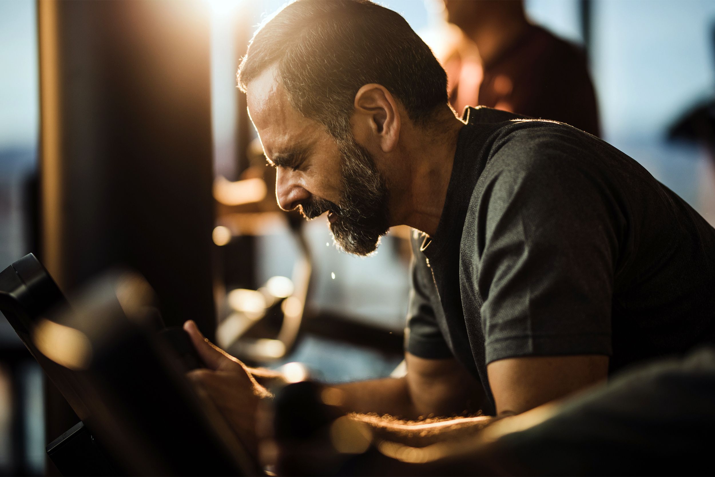 Man sweating while exercising at the gym