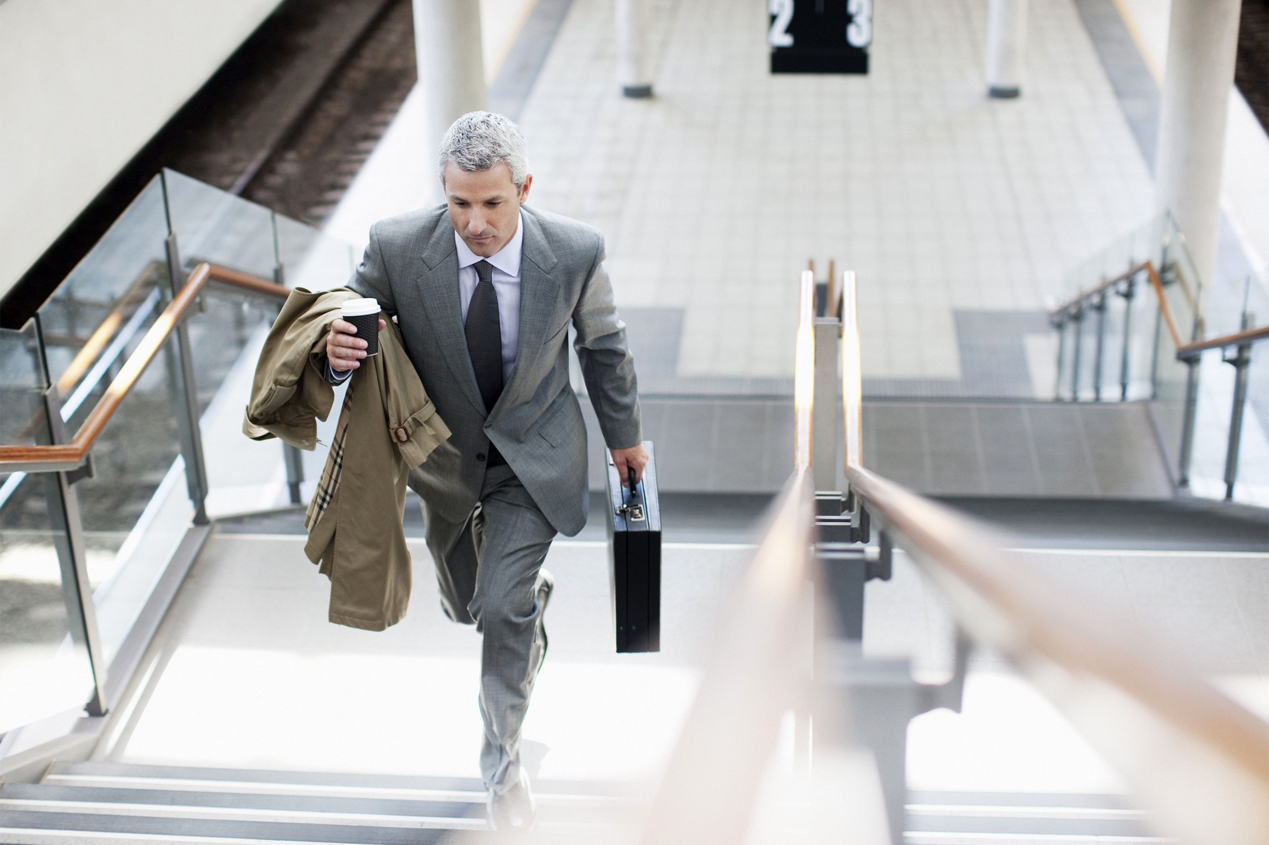 Older business man walking up stairs