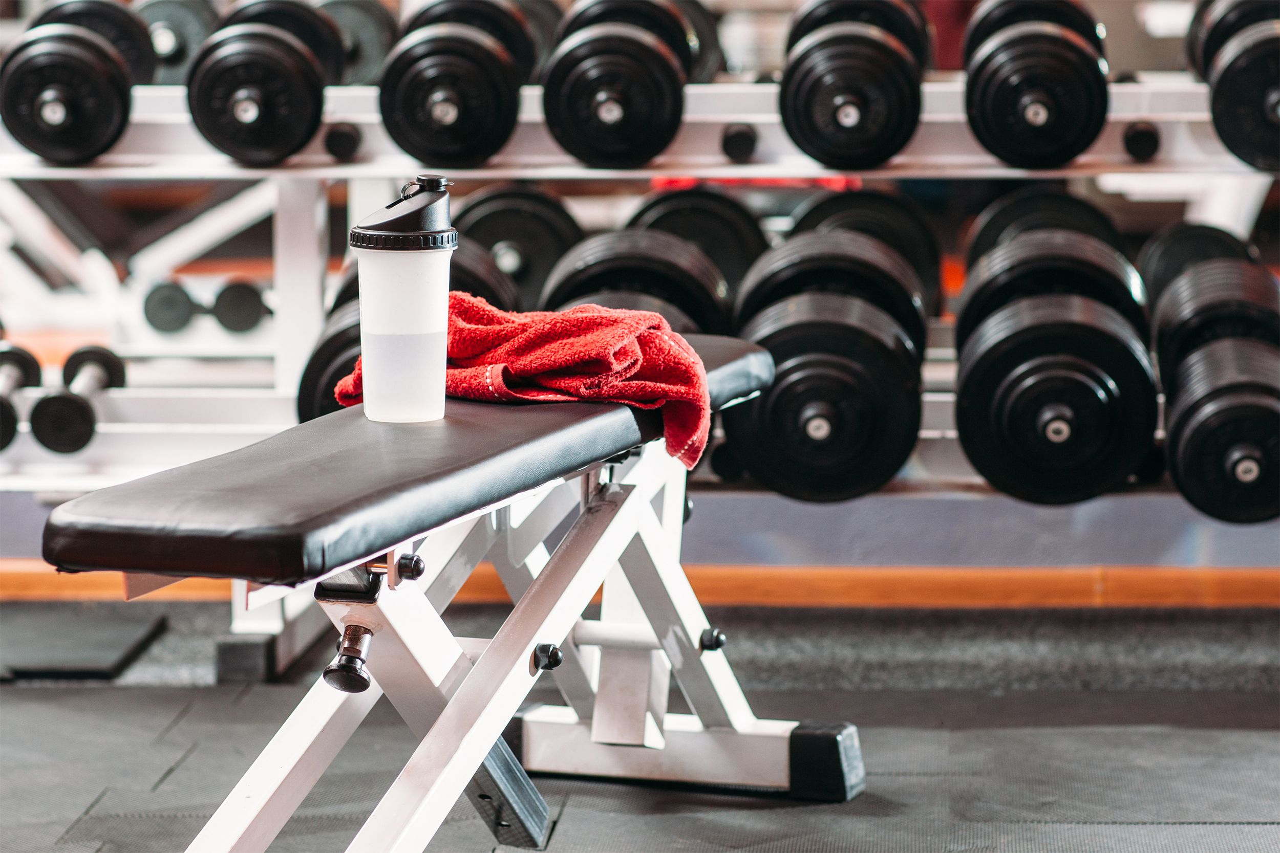 Towel and water bottle on a weight bench