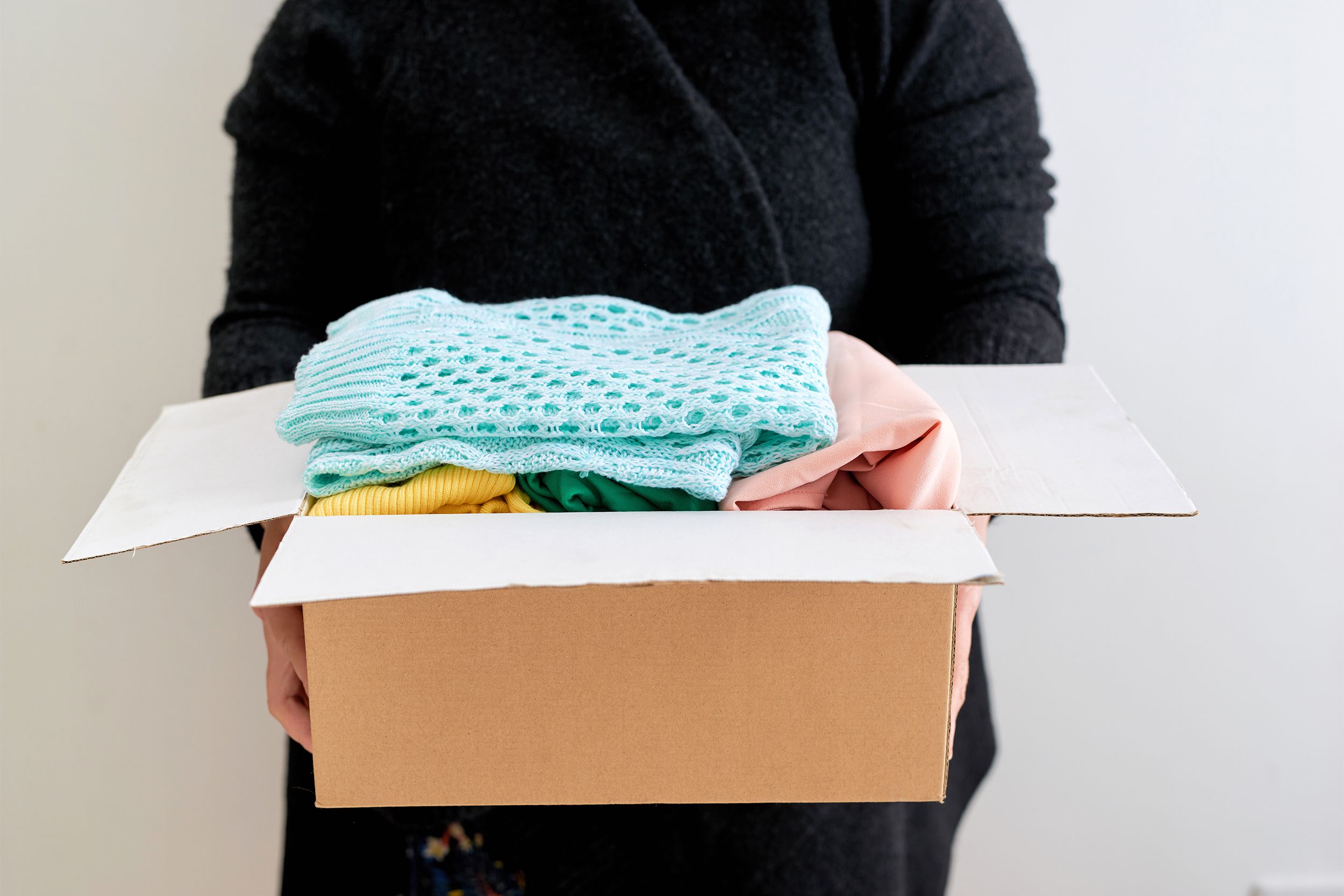 Man holding a clothes donation box