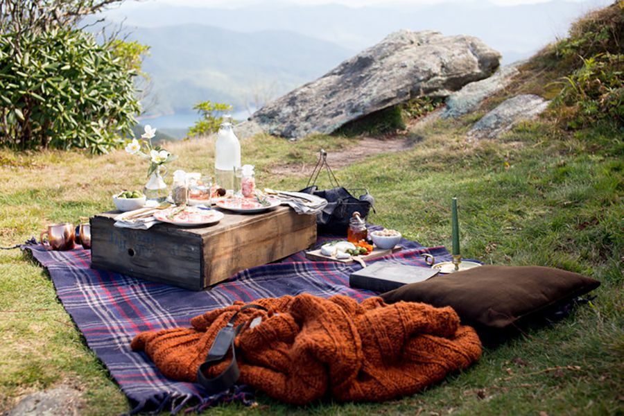 picnic basket and blanket, mountain in background