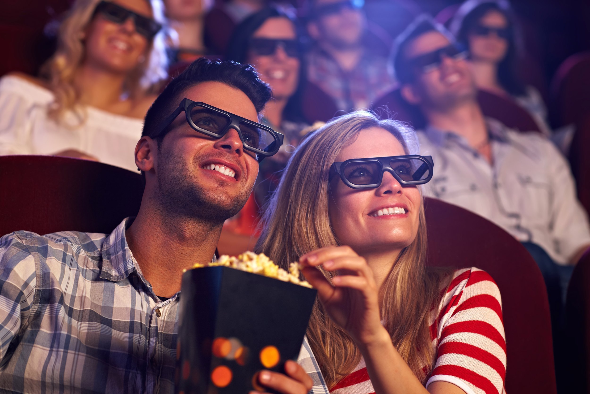 happy couple sitting in movie theater