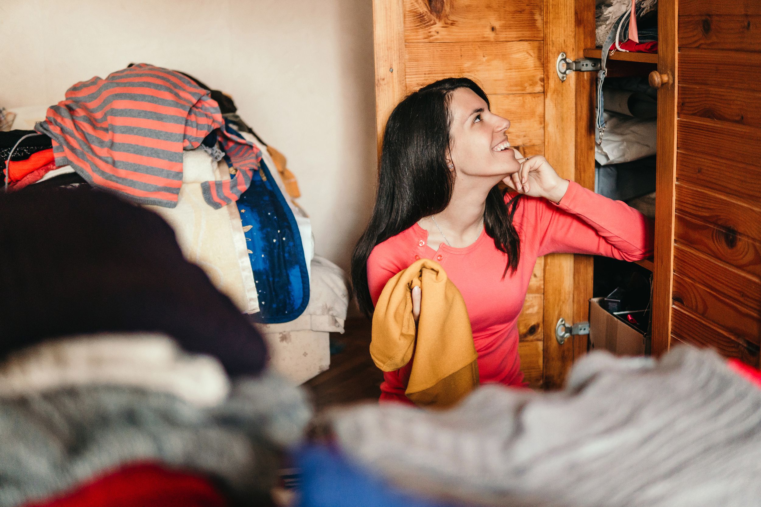woman sorting out wardrobe in closet