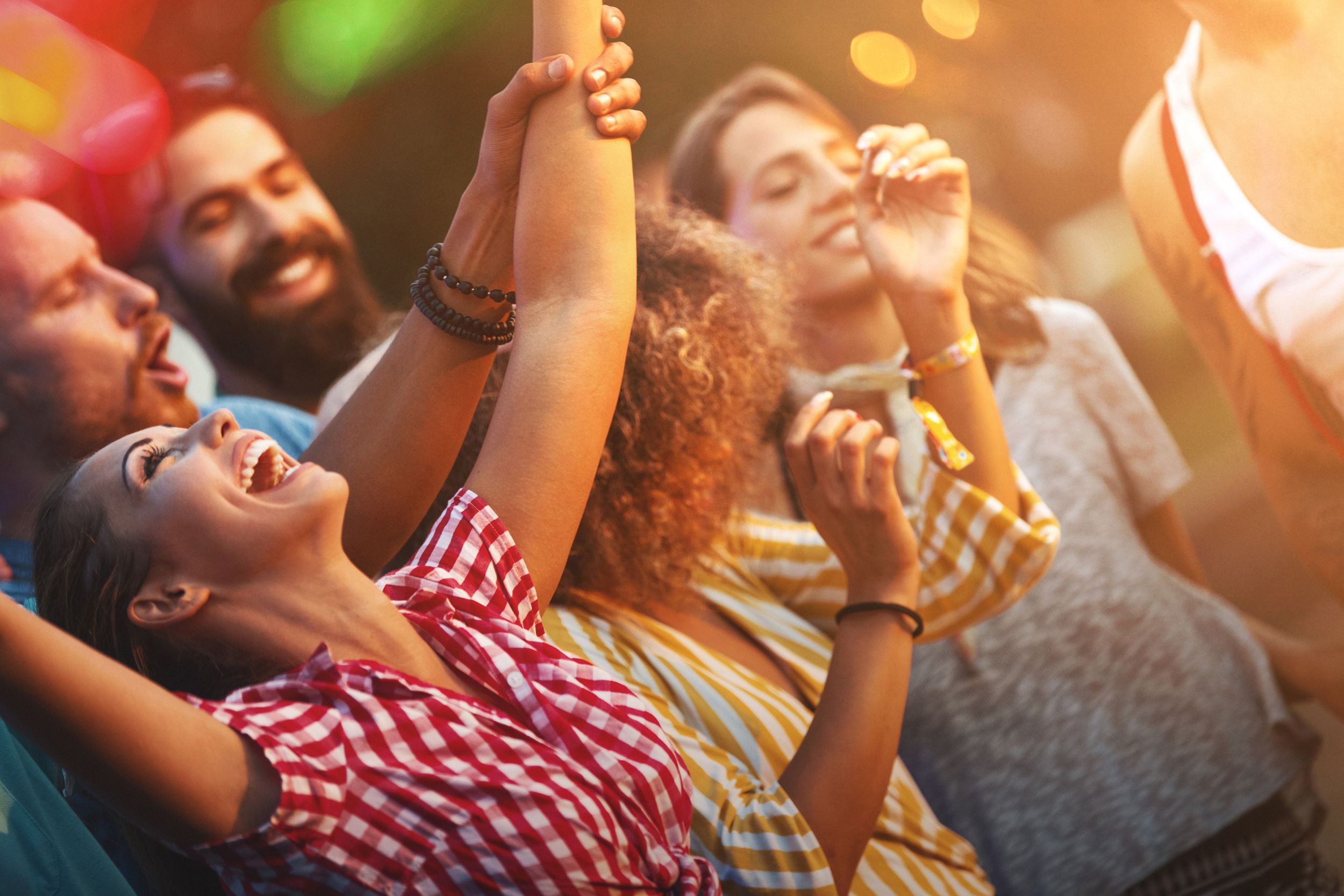 friends dancing at an outdoor concert