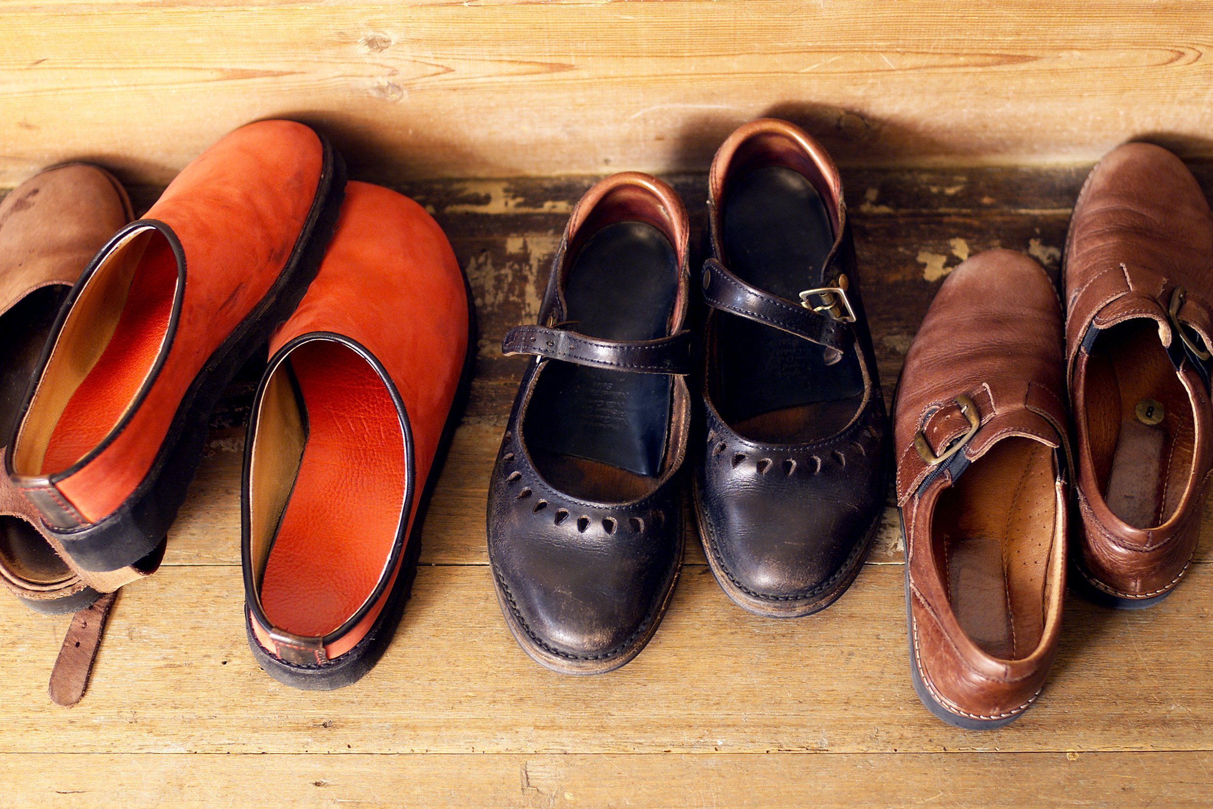 row of shoes lined up near house front door