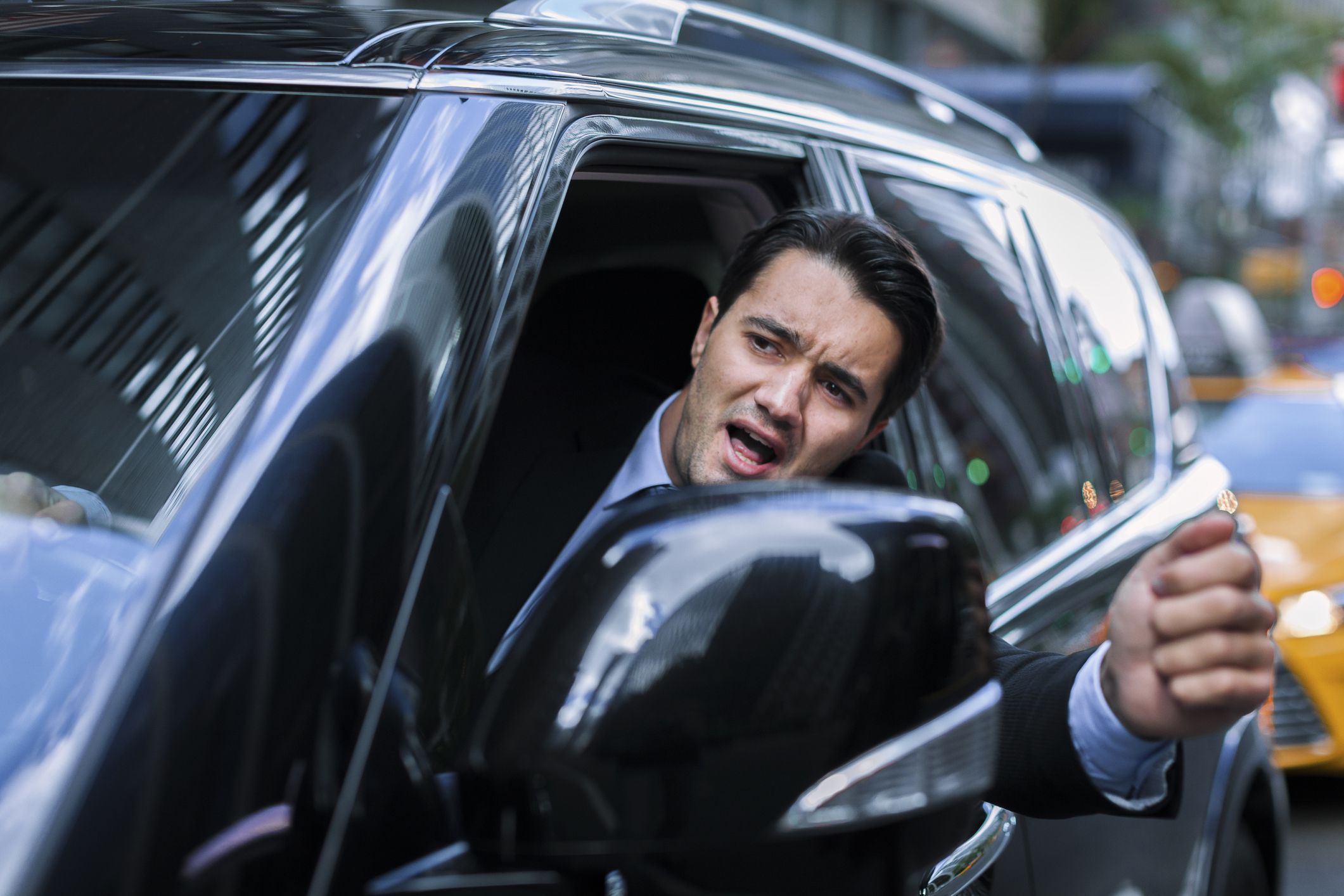 nyc driver leaning out of car to yell