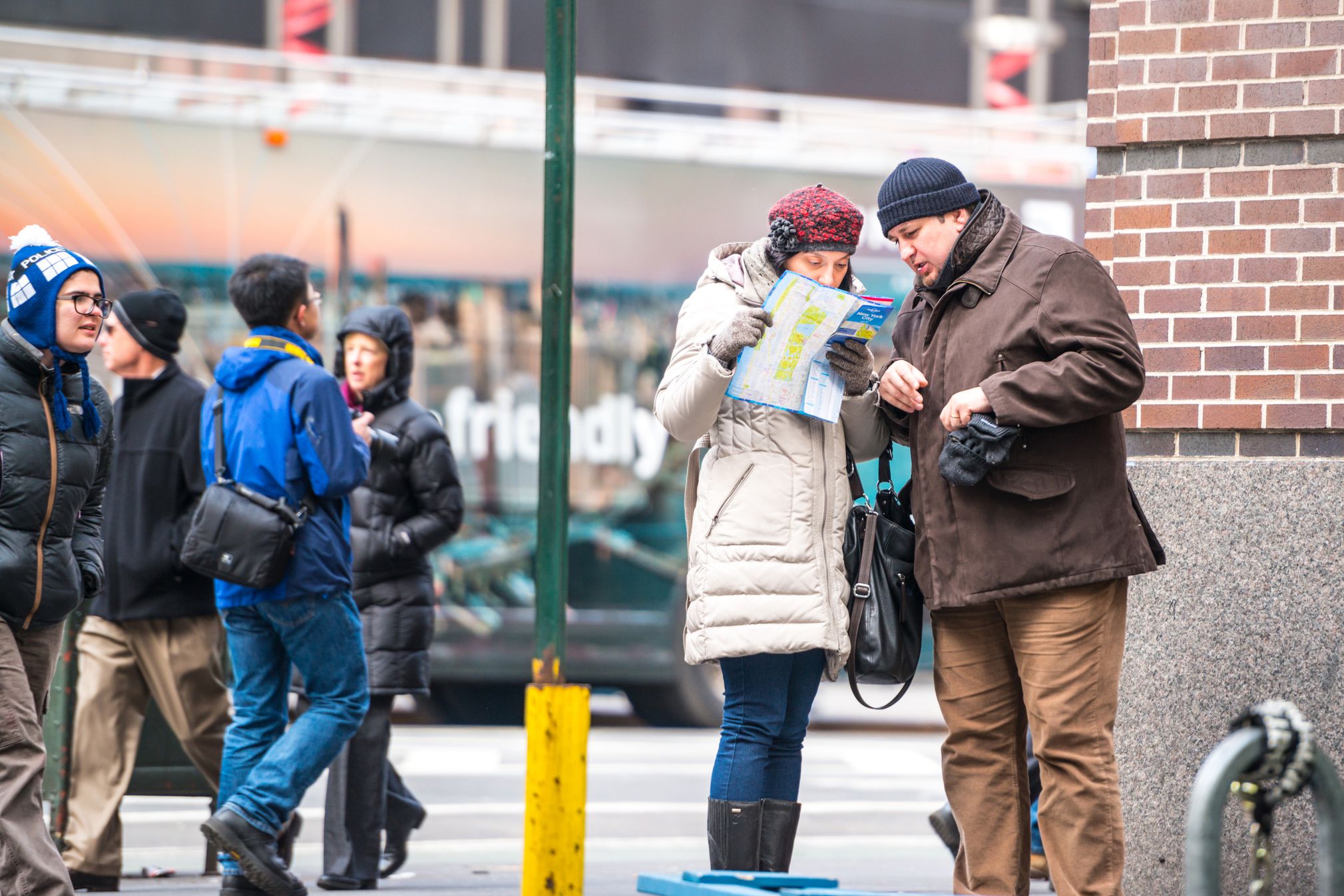 two tourists looking at nyc map