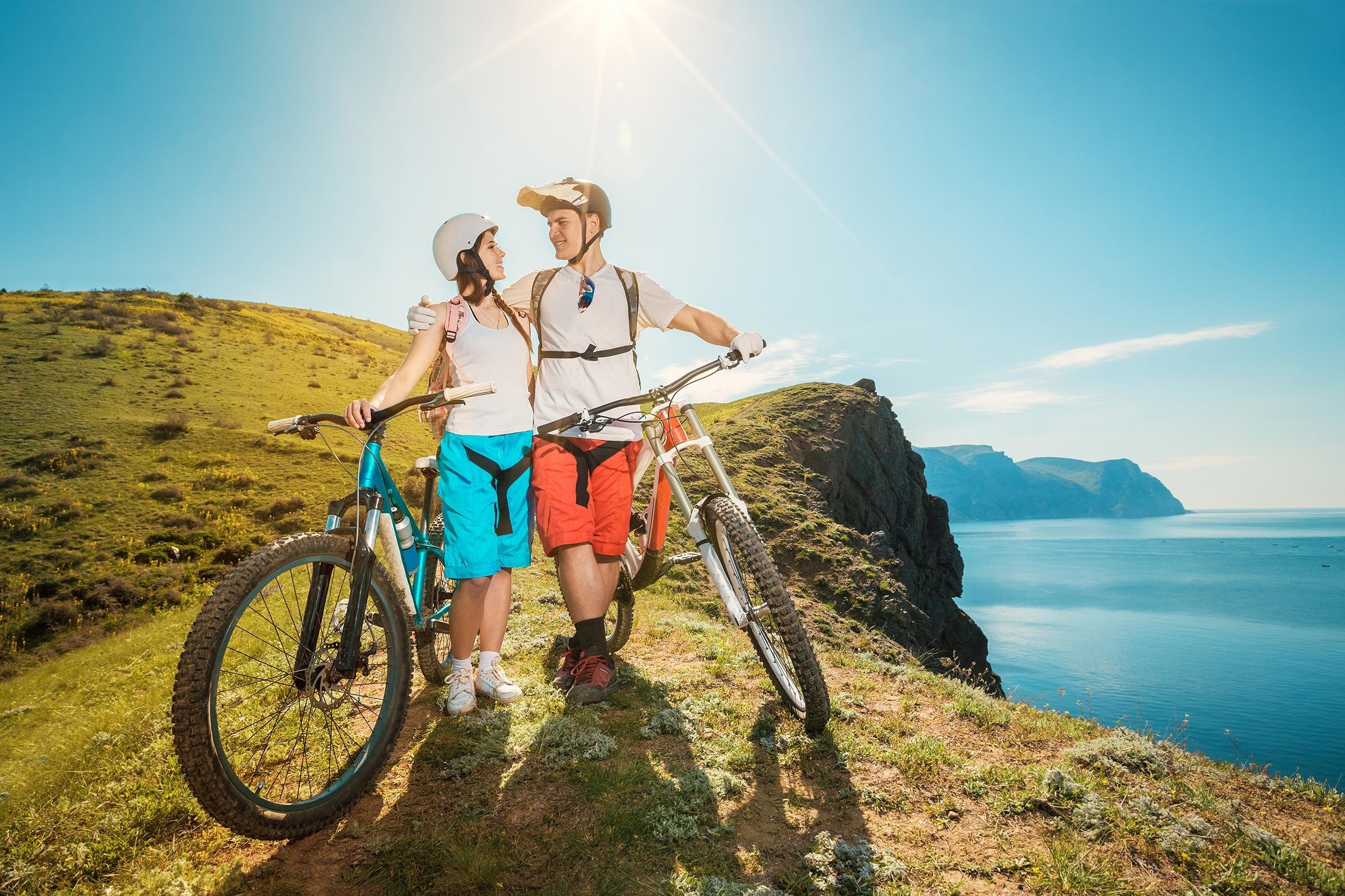 happy couple in the mountains with bicycles