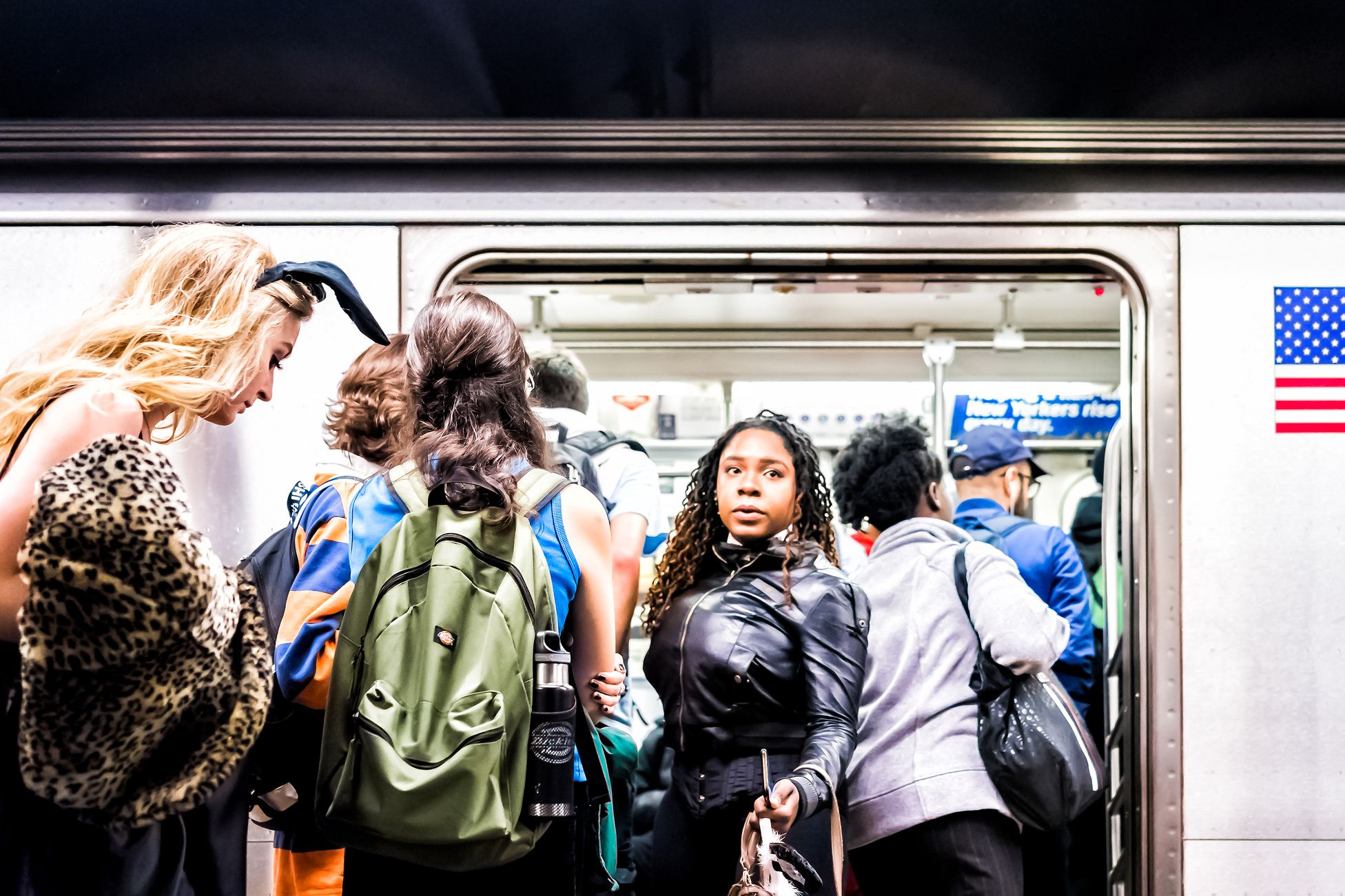people trying to enter and exit subway car in nyc