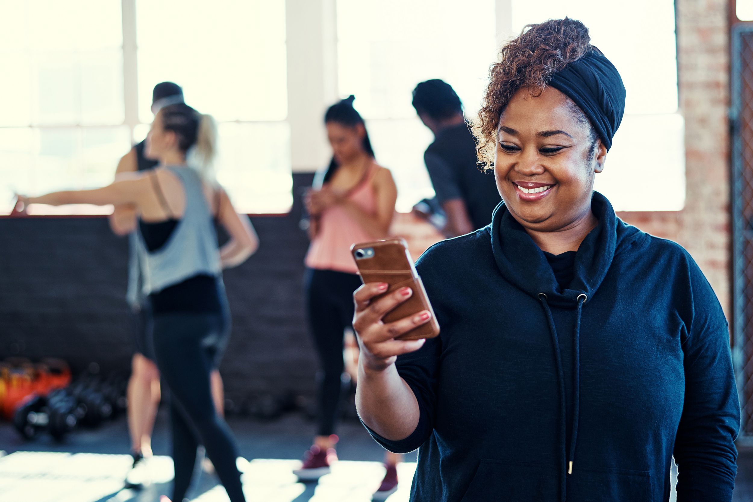 Woman using phone at the gym