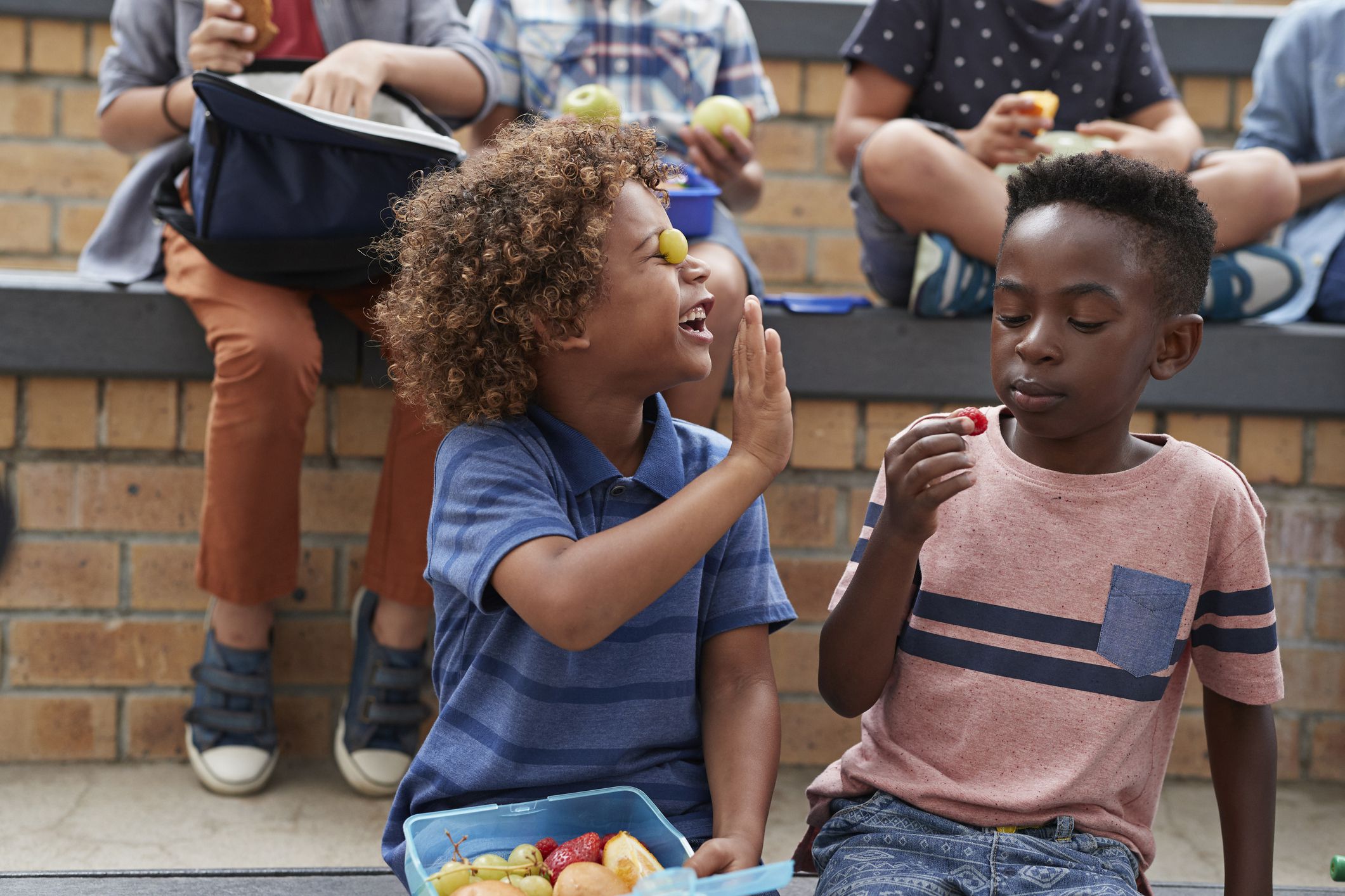 school children having lunch together outside the building in cape town