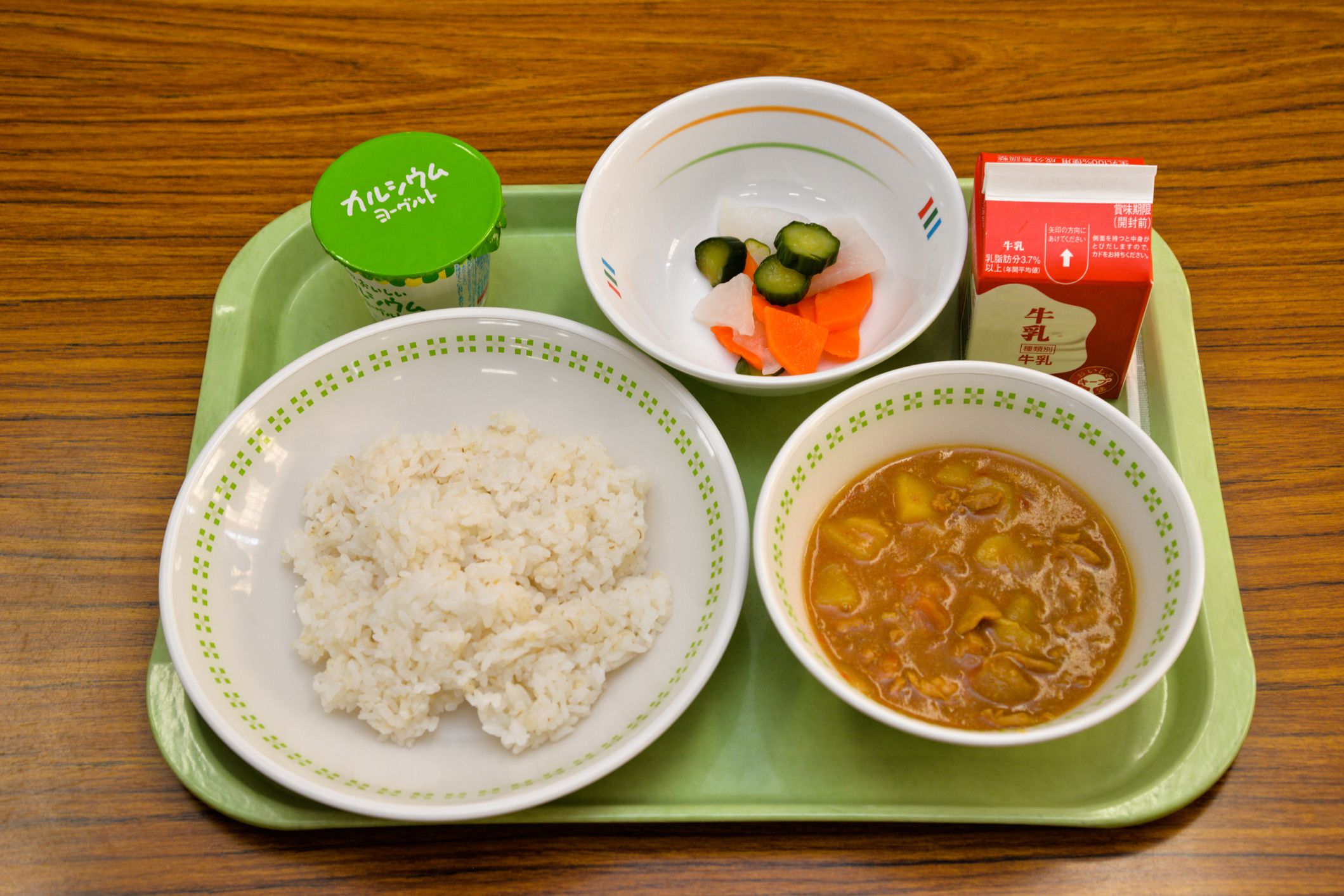 school lunch which is made of all domestic food, for junior high school students in kawasaki japan. curry, wheat rice, pickled cucumber and carrots and radish, yogurt, milk