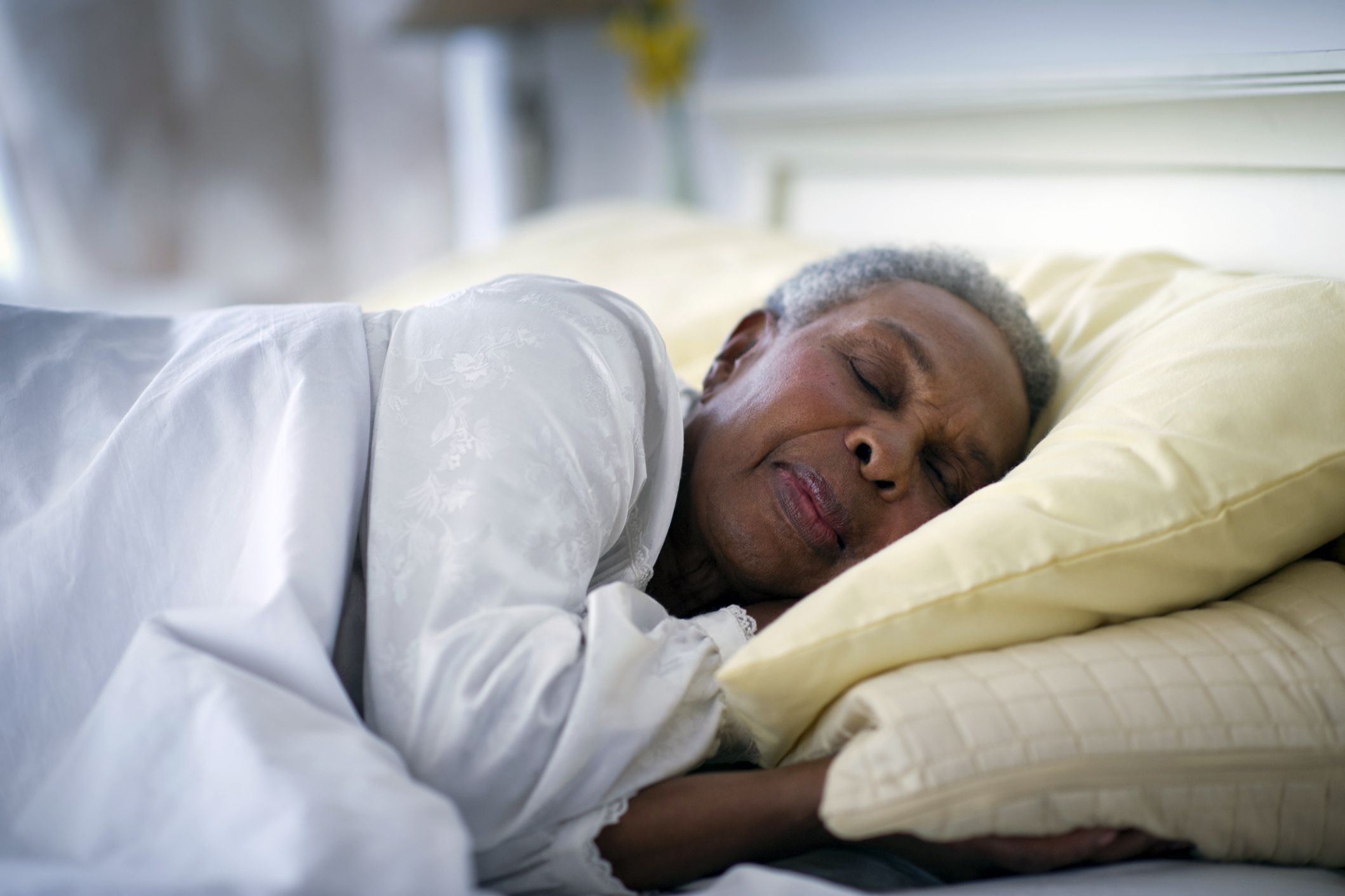 senior woman sleeping in bed