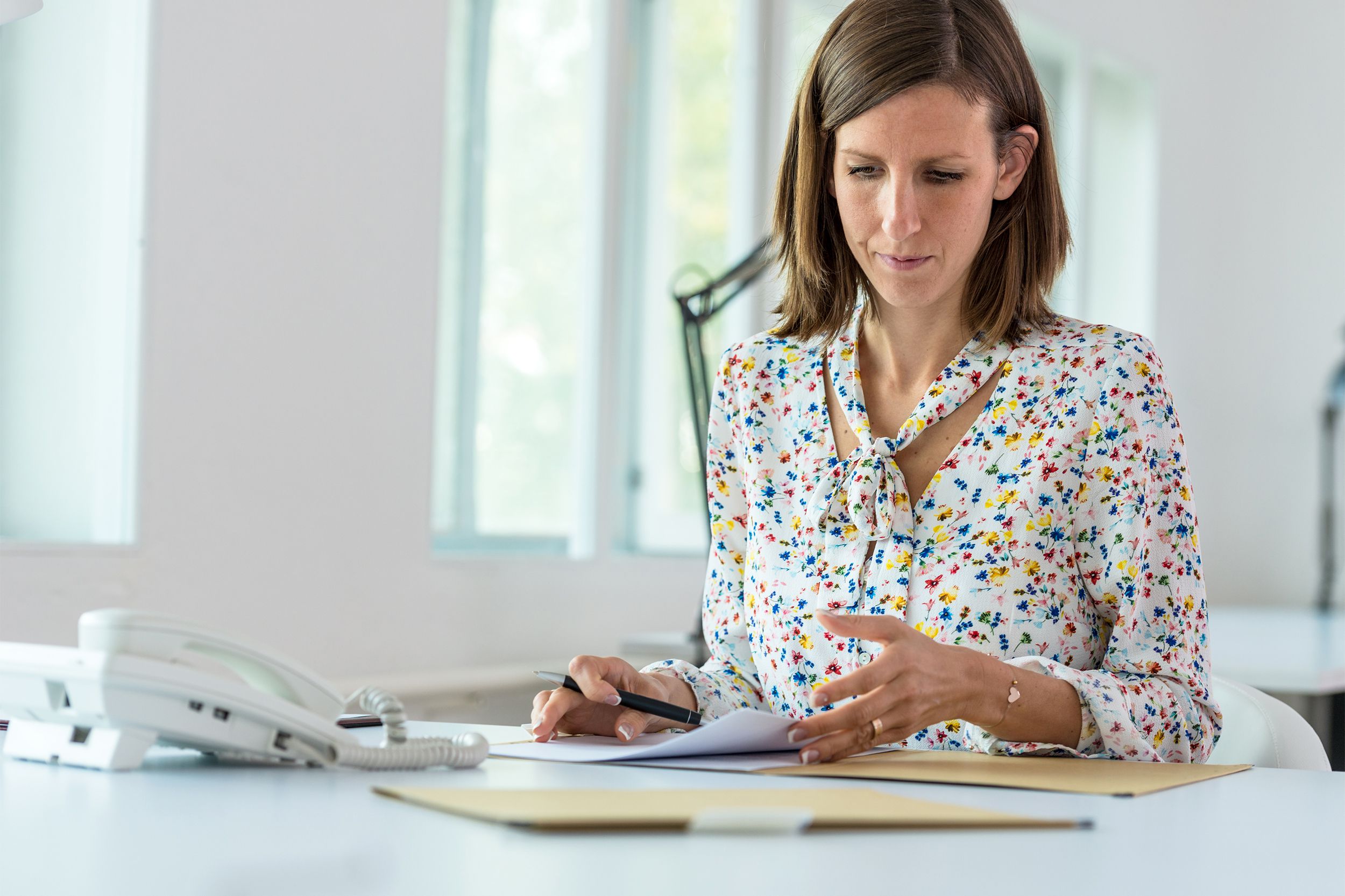 Young businesswoman sitting at her office desk working
