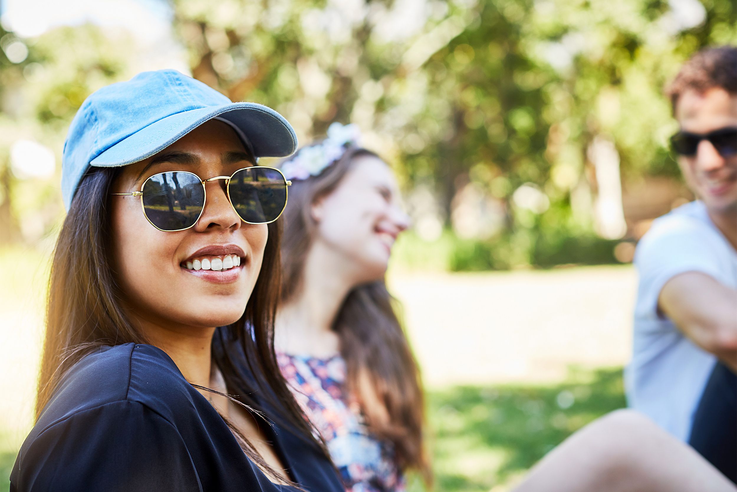 Woman wearing a baseball cap and sunglasses
