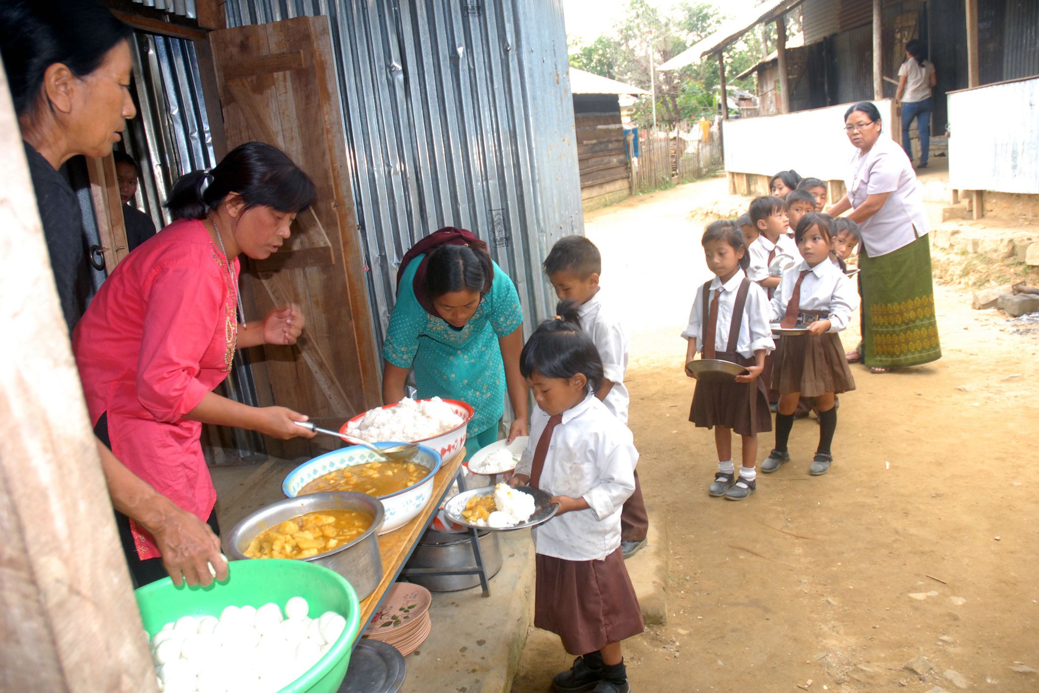 children being served the food under the mid-day meal scheme at a primary school, wokha district in nagaland