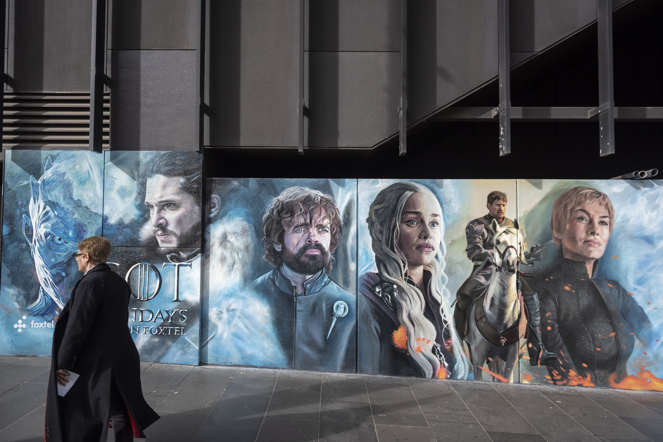 game of thrones advertisement on city corner in melbourne, pedestrian walking by