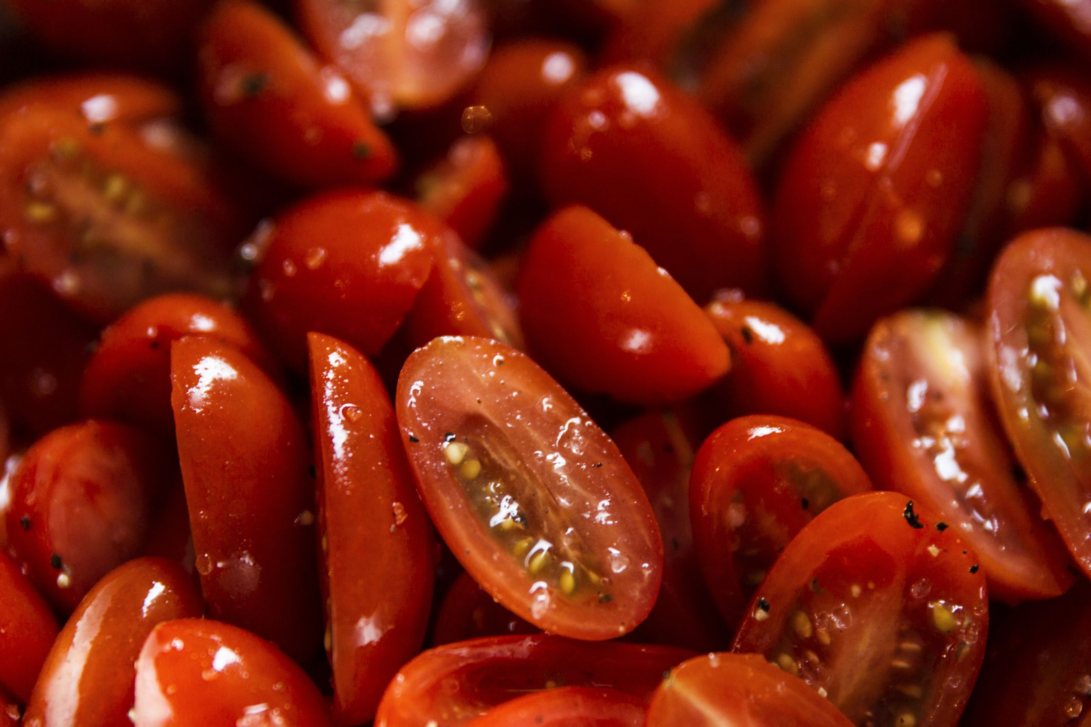 sliced cherry tomatoes with salt, pepper, and oil
