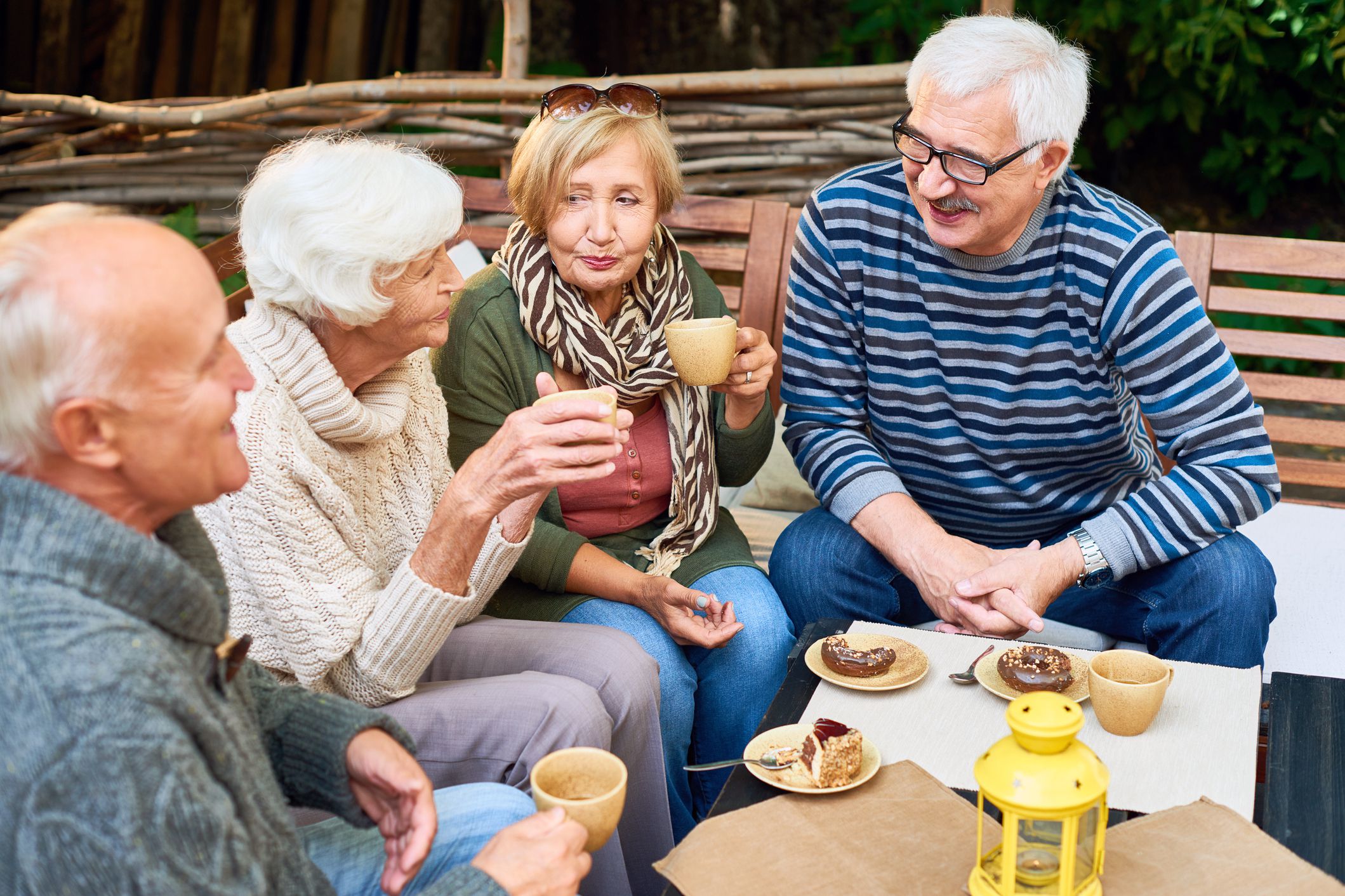 group of four seniors talking outdoors