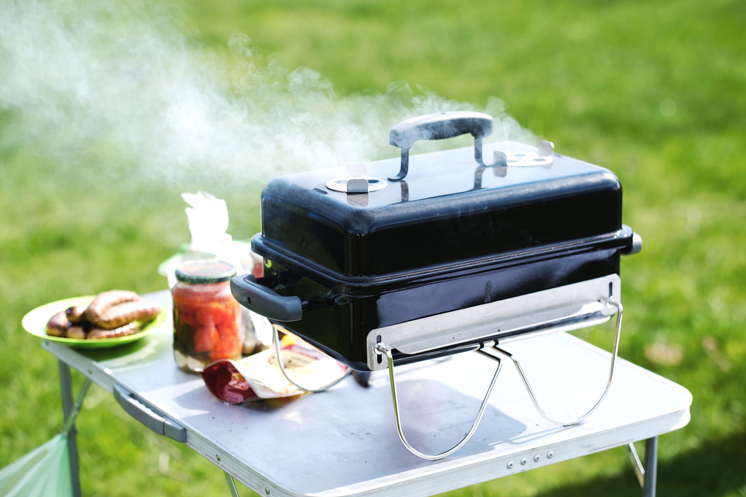 Small outdoor grill on a table in the summer