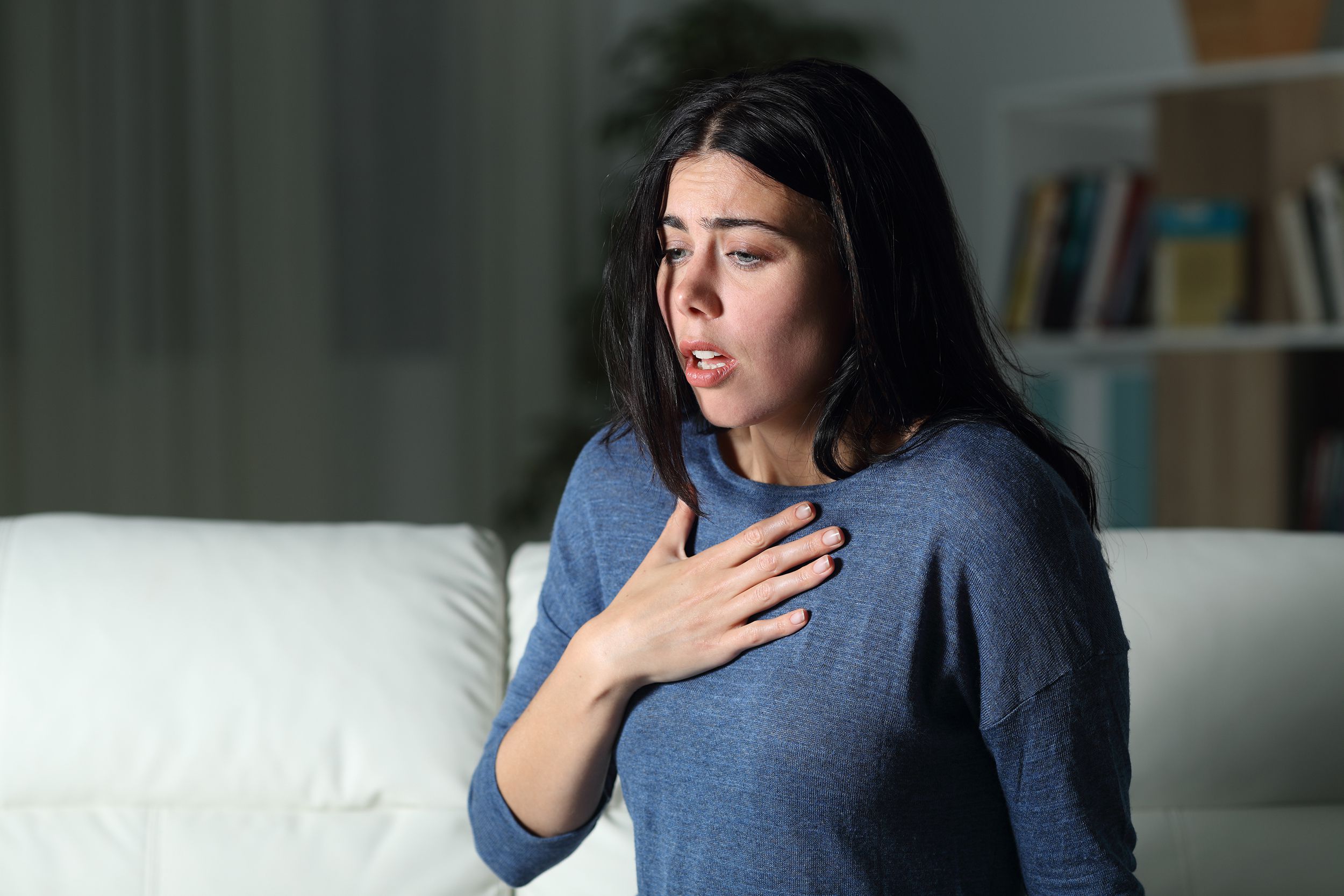 woman suffering an anxiety attack alone in the night