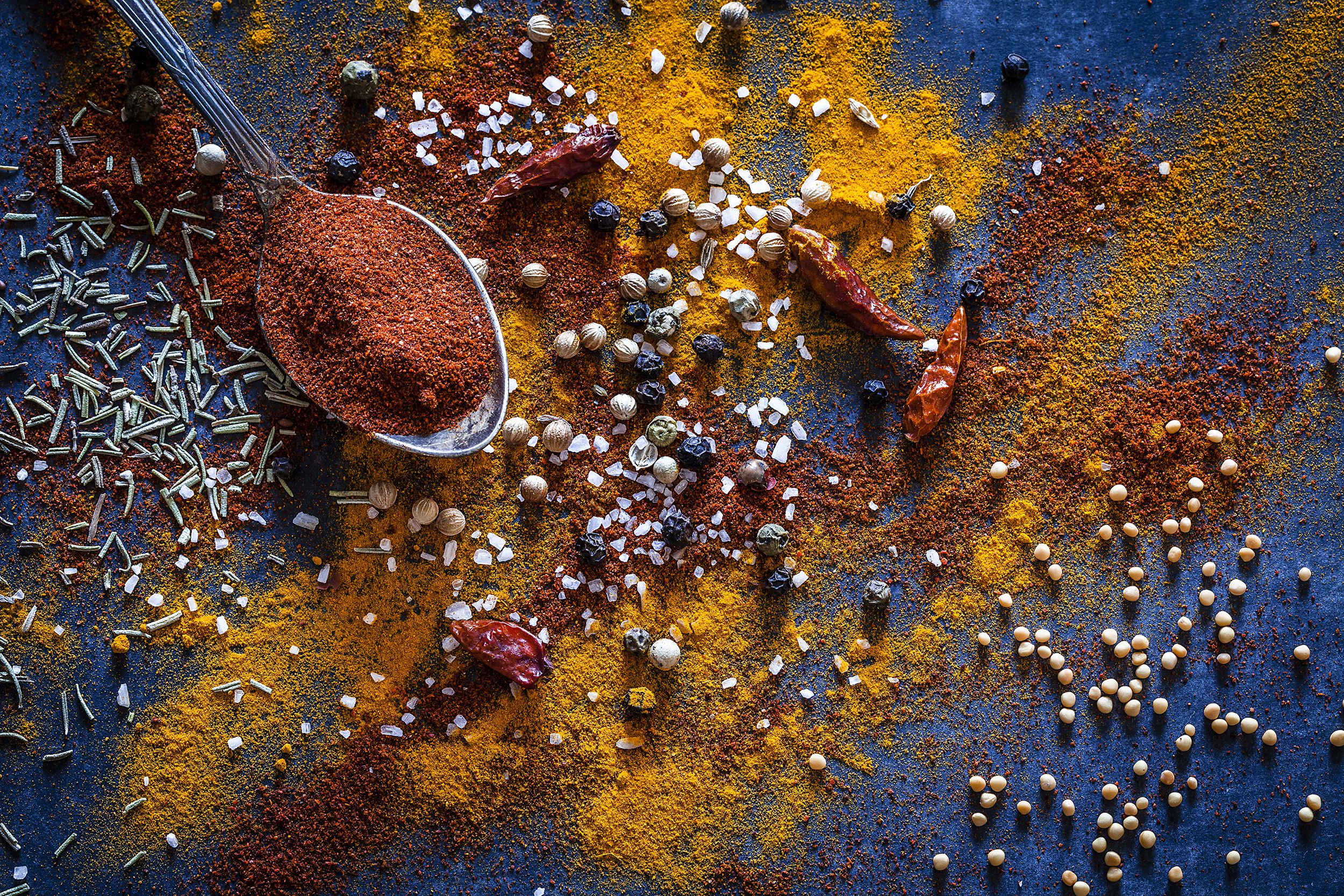 various spices scattered on table