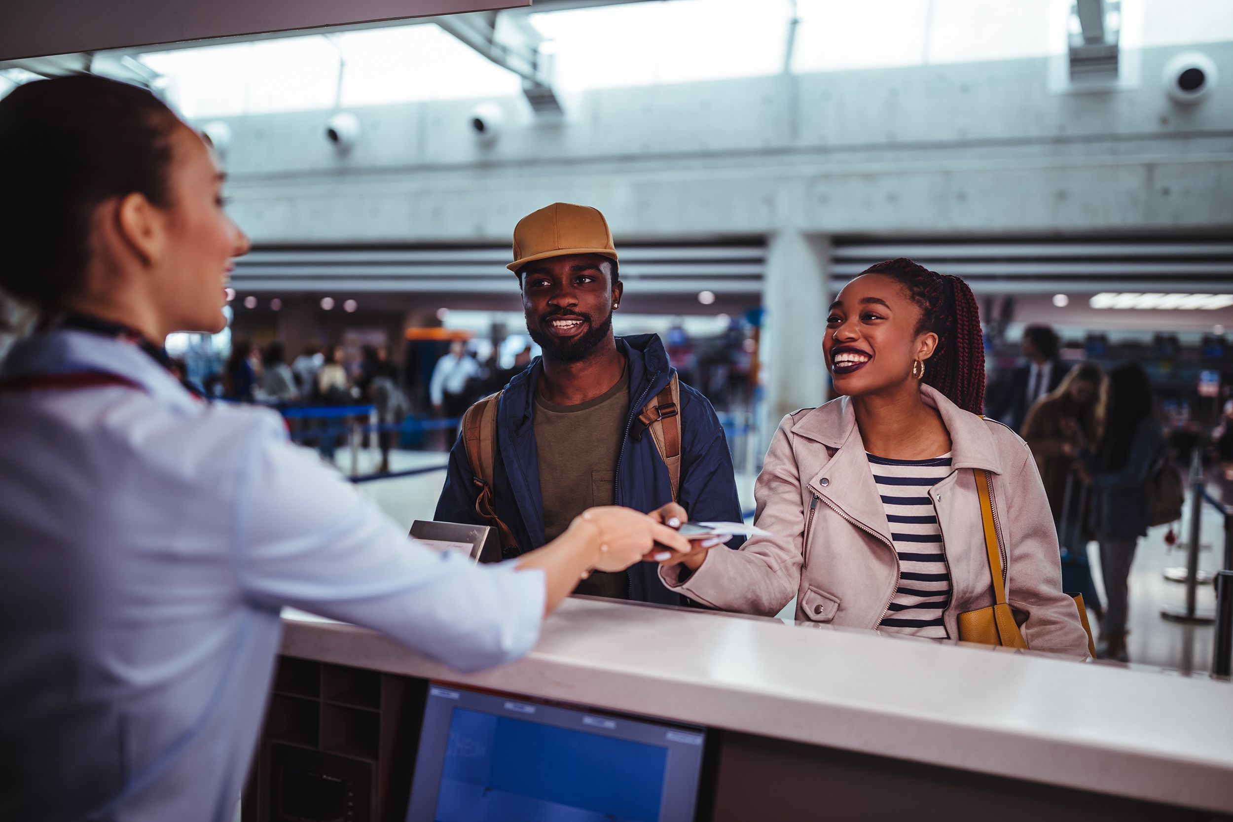 young passengers doing check-in for flight at airport