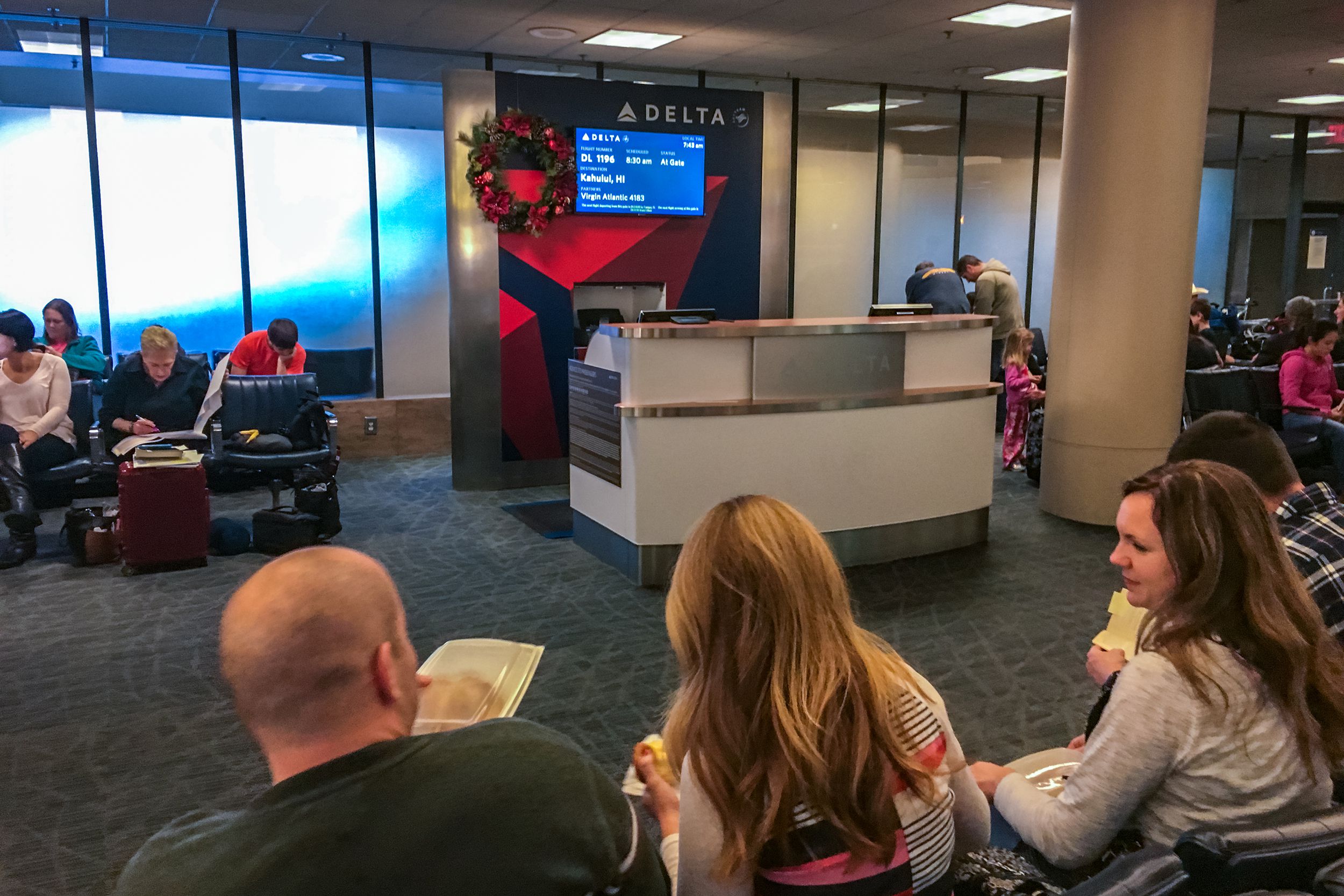 people waiting for flight to Hawaii in Los Angeles Airport