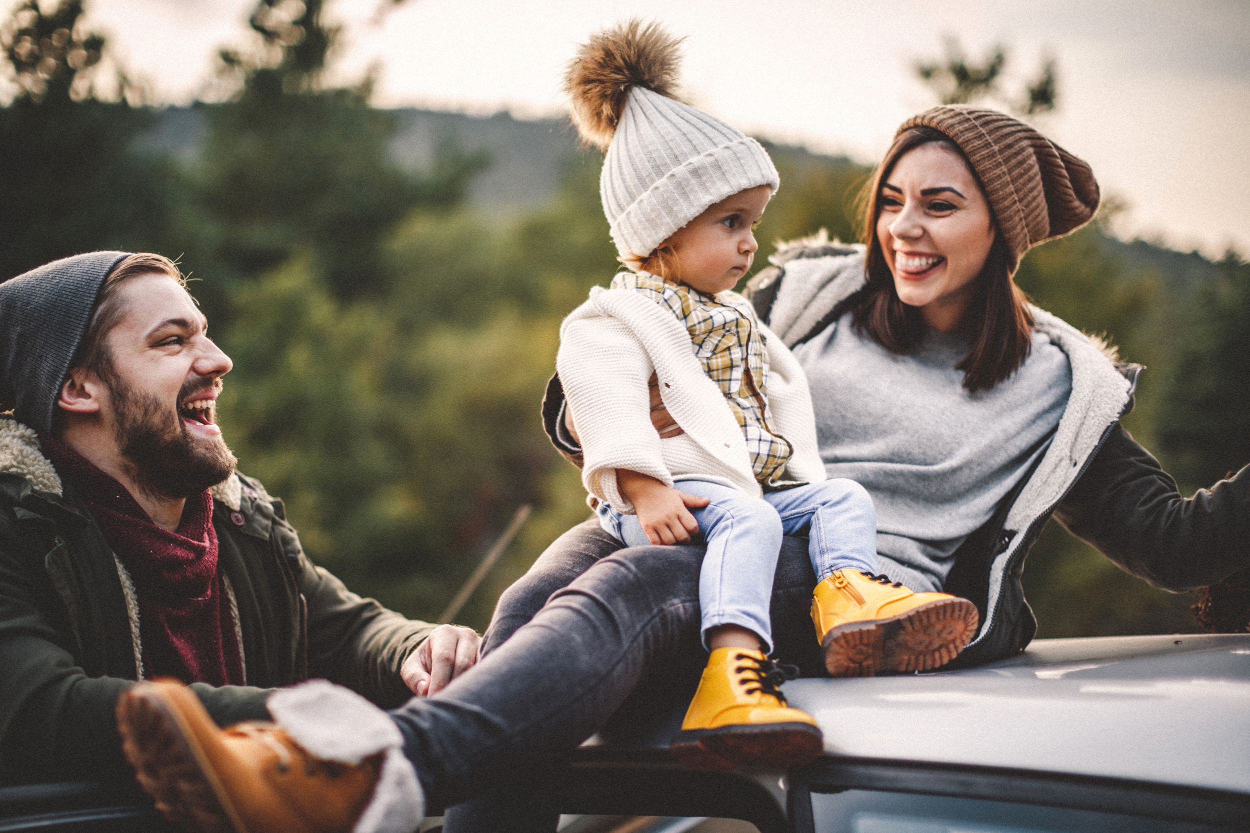 happy family on top of car