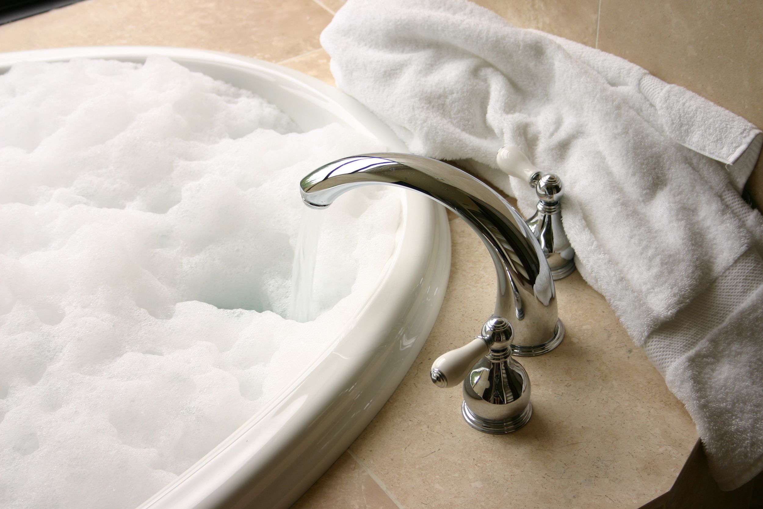 faucet running water into bubble bath
