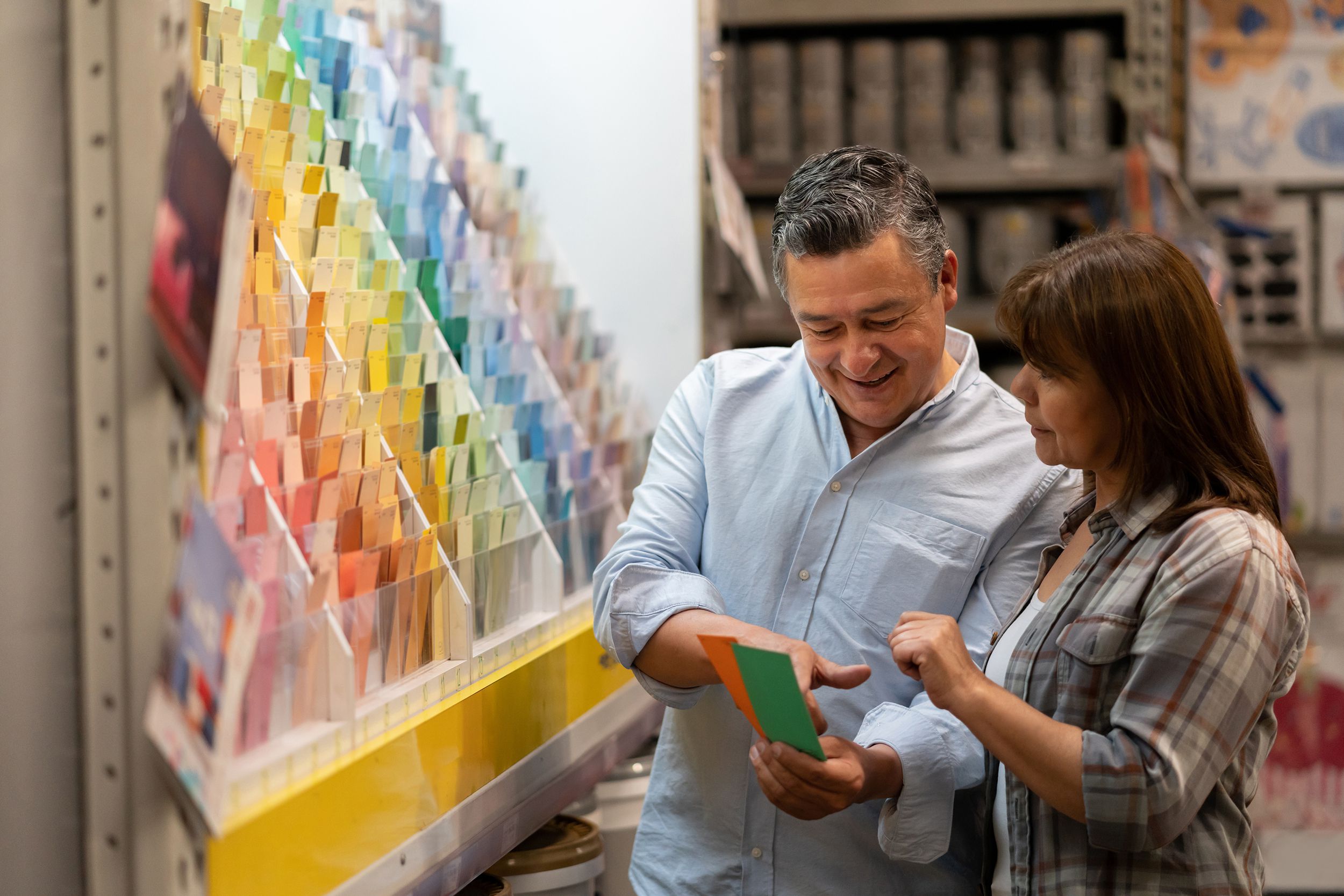 loving couple at home improvement store choosing a color to paint their house