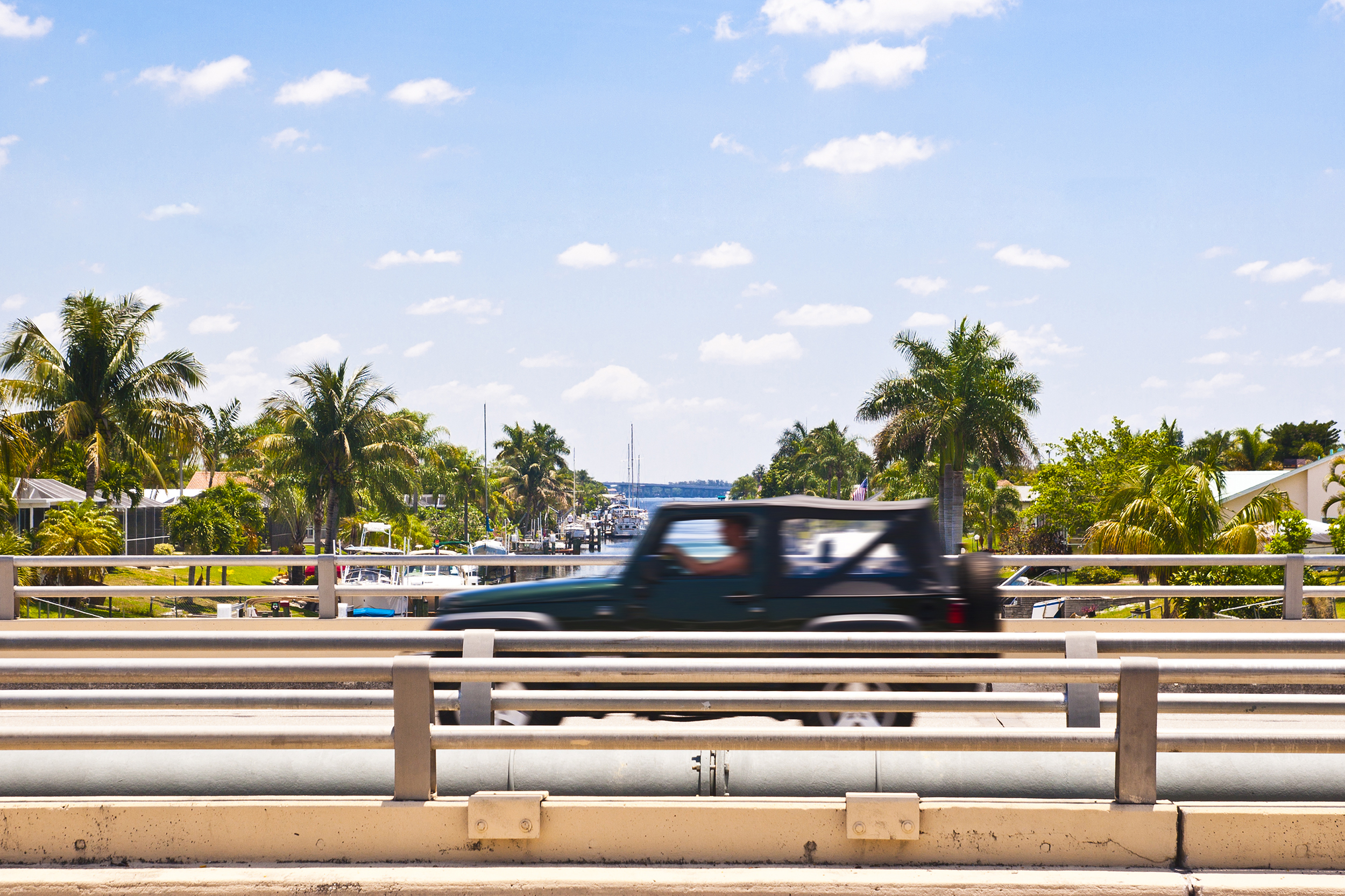 driver over canal bridge in Cape Coral, Florida