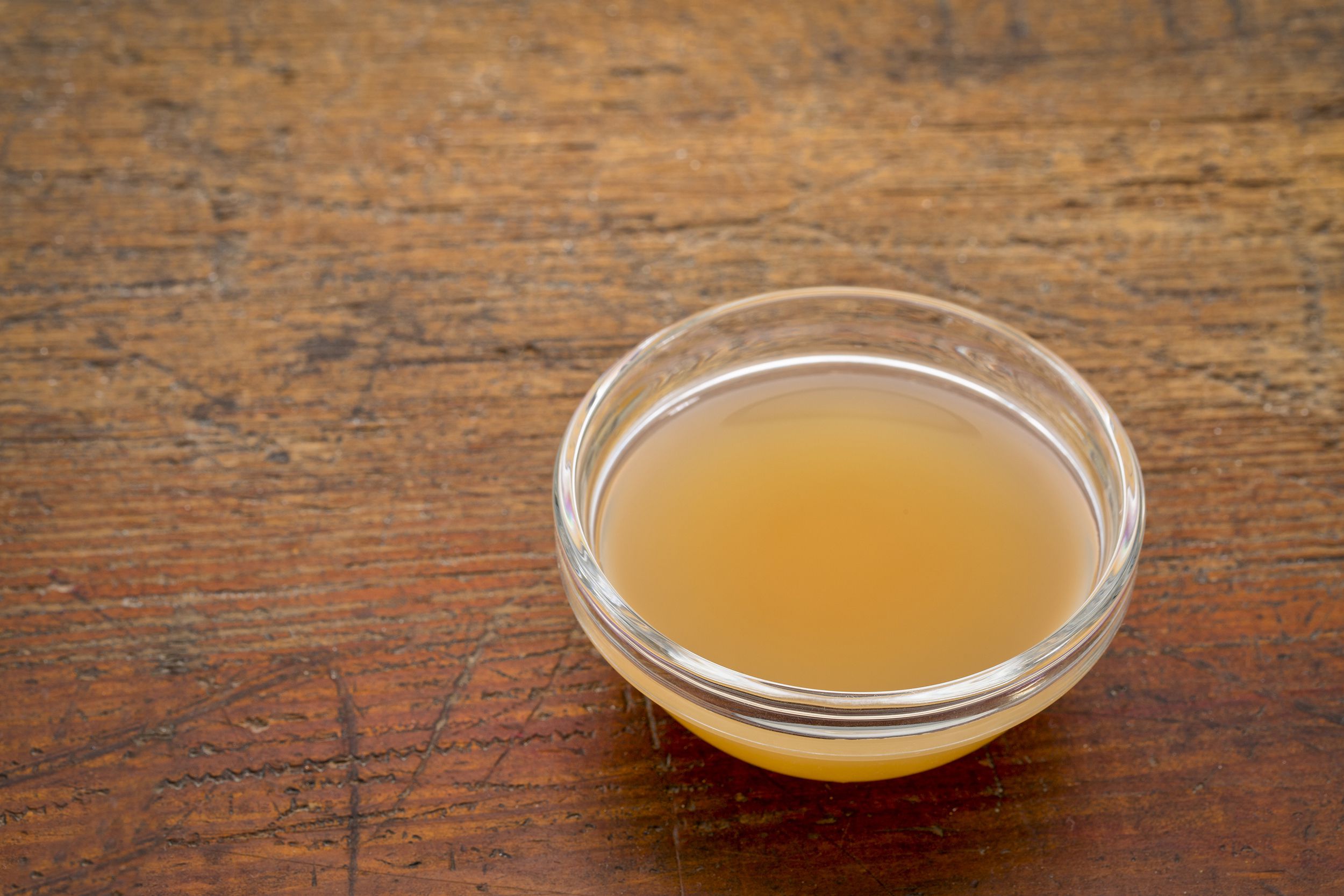raw apple cider vinegar in bowl on table